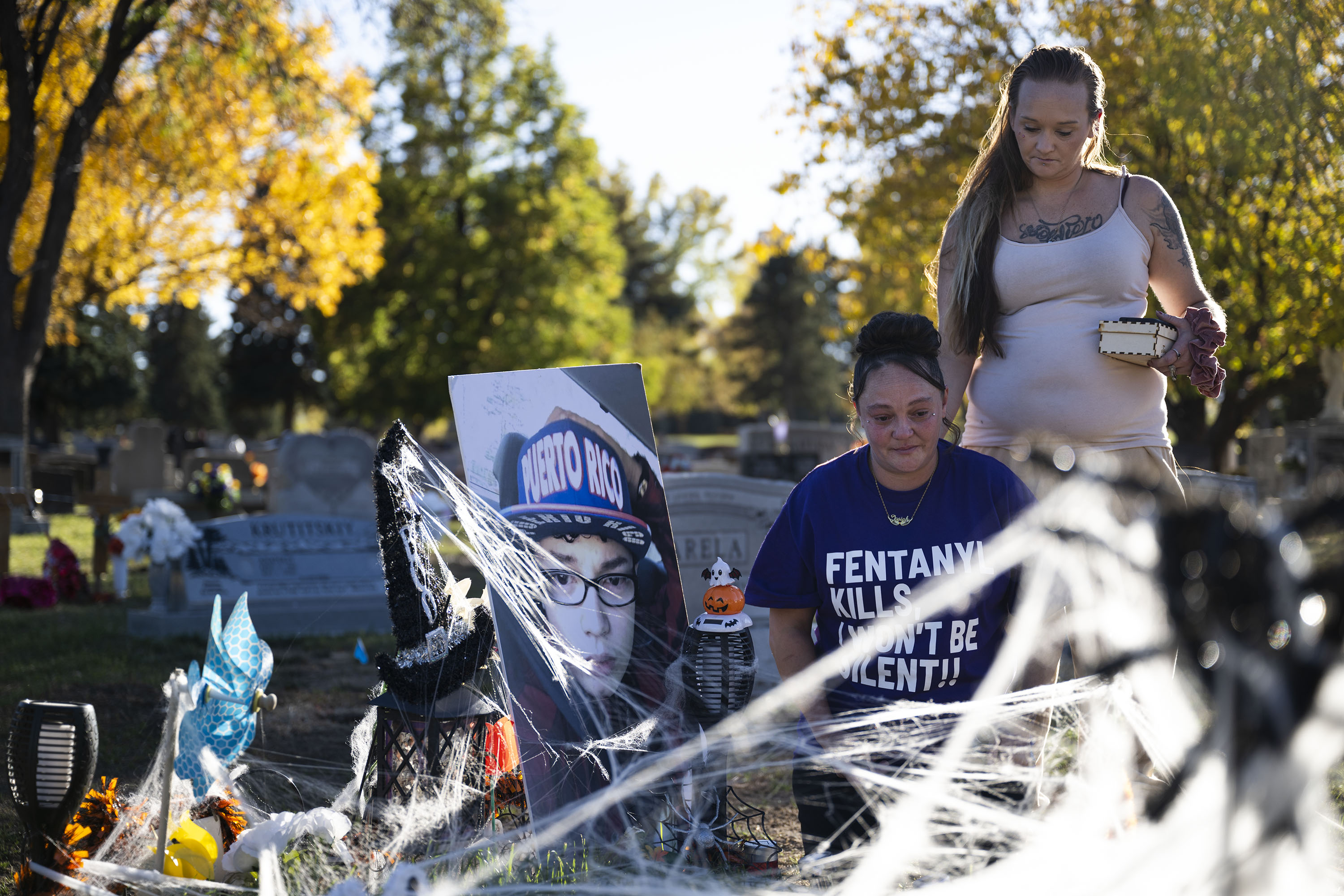 Christina Luna, the mother of Josiah Velasquez, and her close friend and sister Tara Garcia spend time at Josiah’s grave that’s been decorated for Halloween on Thursday, Oct. 20, 2022, at the Crown Hill Cemetery in Lakewood, Colo. Luna and Garcia visit the site often and bring a large photo of Josiah with them each time they visit. (Timothy Hurst/The Gazette) (TimHursttim.hurst@gazette.comhttps://secure.gravatar.com/avatar/aca82bd62b4ee425c598527cd6faa1b1?d=mm&r=g)