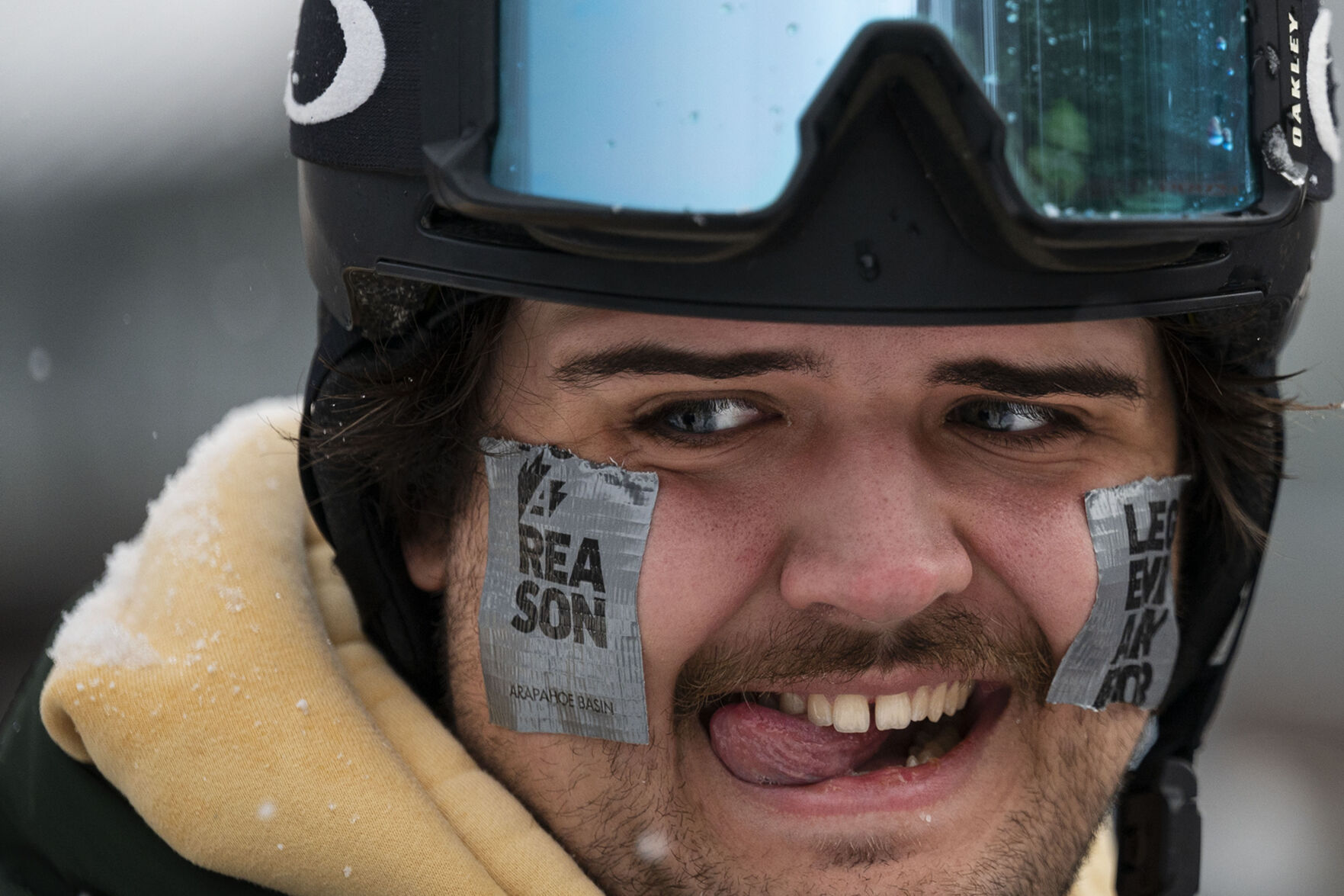 Hampton Terrell wears squares of duct tape on his cheeks while waiting in line for the Black Mountain Express Lift to open during opening day at Arapahoe Basin Ski Area on Sunday, Oct. 23, 2022, near Dillon, Colo. (Timothy Hurst/The Gazette) (TIMOTHY HURST/DENVER GAZETTE)