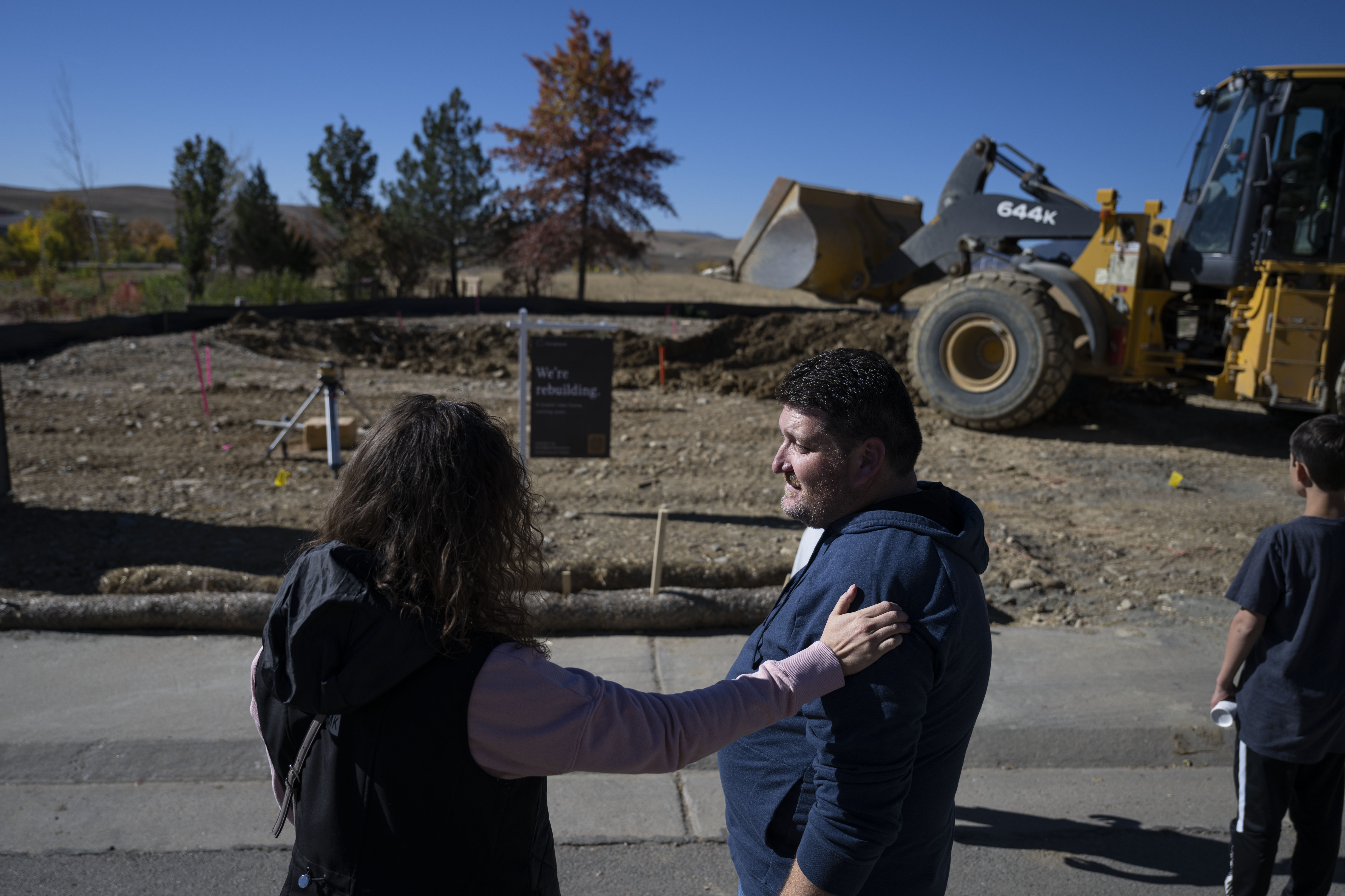 Neighbors who lost their homes in the 2021 Marshall Fire, Jenna Iszler and Chad Cheek watch as a bulldozer excavates Cheek’s property ti begin rebuilding his home on Wednesday, Oct. 19, 2022, in Superior, Colo. Multiple neighbors came out to watch the groundbreaking which is the first in their neighborhood. (Timothy Hurst/The Gazette) (TimHursttim.hurst@gazette.comhttps://secure.gravatar.com/avatar/aca82bd62b4ee425c598527cd6faa1b1?d=mm&r=g)