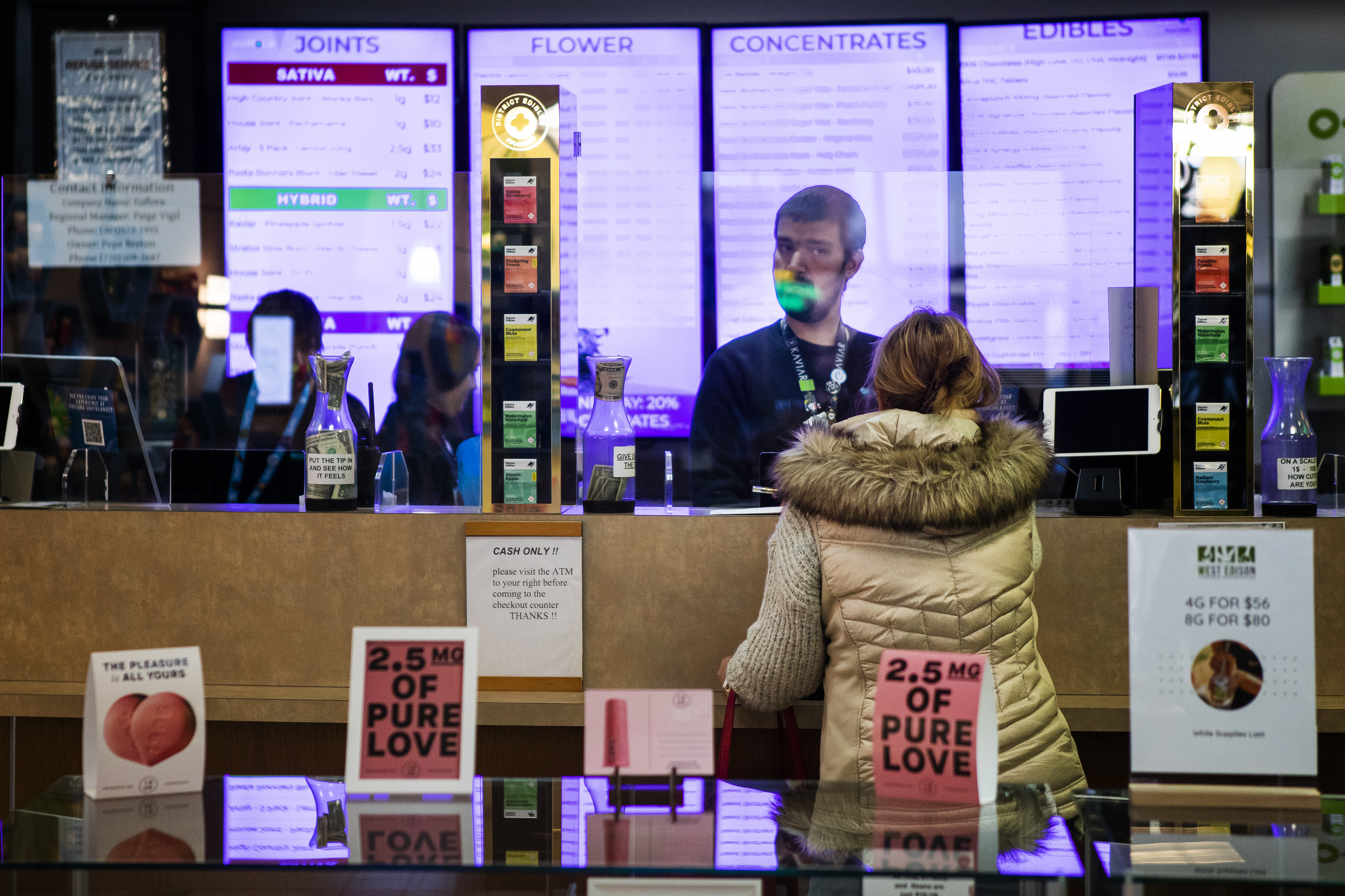 FILE PHOTO: A customer works with bud tender Jason Mckee at Euflora Recreational Marijuana Dispensary. Sales are down substantially, by $72 million over their highwater mark during the pandemic summer of 2020, according to Colorado Department of Revenue. But for medical marijuana the drop-off has been much more pronounced, down by $25 million or 58% over that period. (TIMOTHY HURST/THE DENVER GAZETTE)