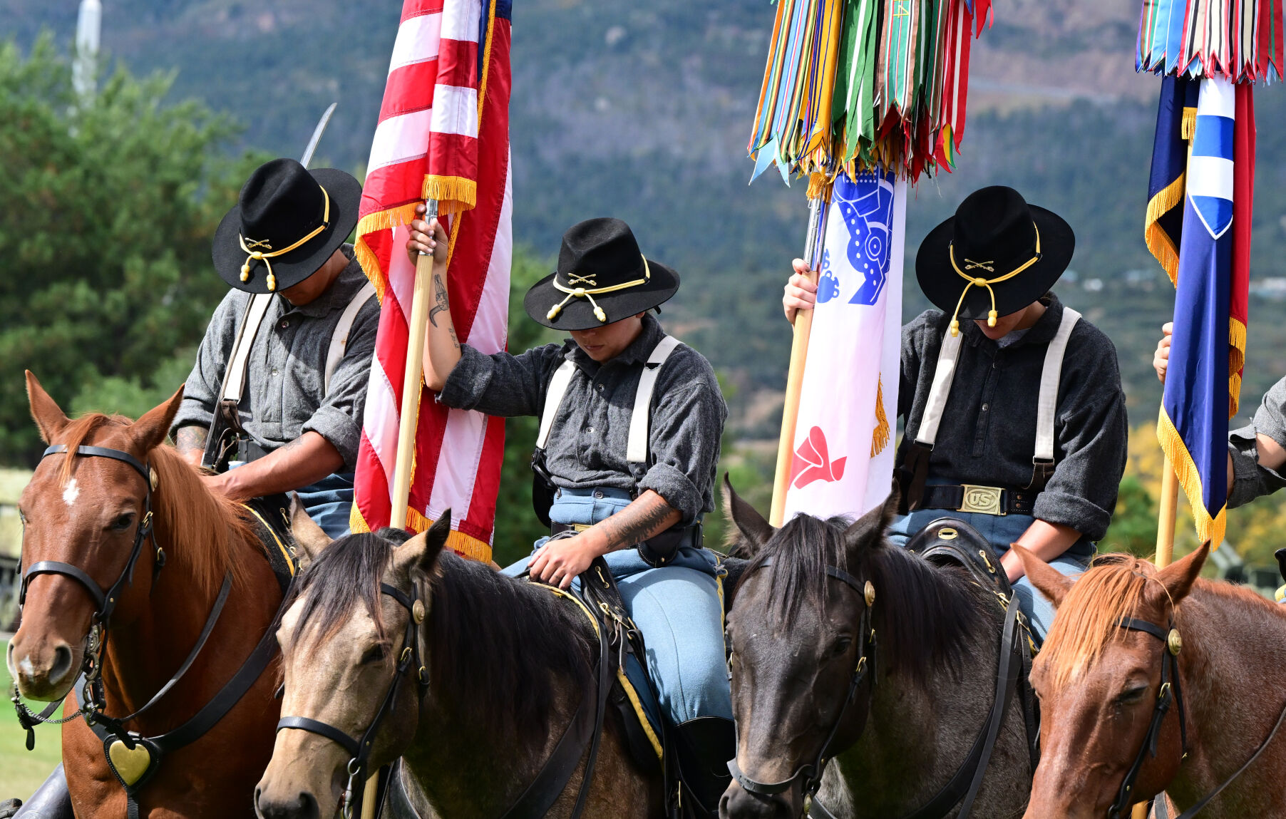 Members of the Fort Carson Mounted Color Guard bow their heads for prayer before a ceremony for World War II veteran Sgt. 1st Class Harold Nelson to receiver the Silver Star during a ceremony at Fort Carson on Tuesday.