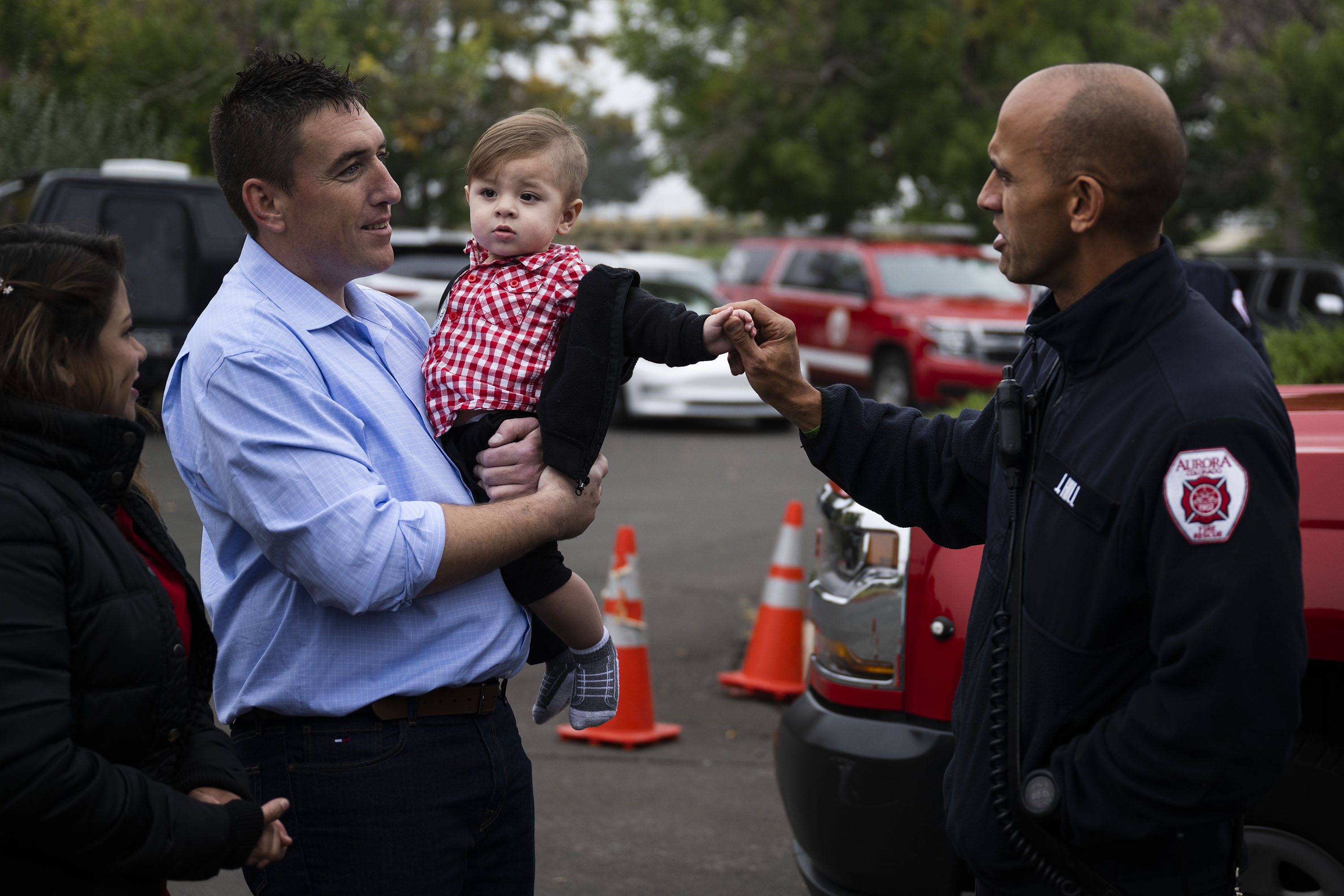 Alexander Thompson, 1, holds the hand of Aurora Fire Department Capt. Joe Hill before a presentation of the Phoenix Award to first responders and to Alexander’s mother Sharon Thompson for their life-saving work when Sharon found Alexander unconscious and not breathing, on Tuesday, Oct. 4, 2022, at Aurora Fire Rescue Station 10 in Aurora, Colo. Alexander is being held by his mother’s boyfriend William Kiernan. (Timothy Hurst/The Denver Gazette) (TimHursttim.hurst@gazette.comhttps://secure.gravatar.com/avatar/aca82bd62b4ee425c598527cd6faa1b1?d=mm&r=g)