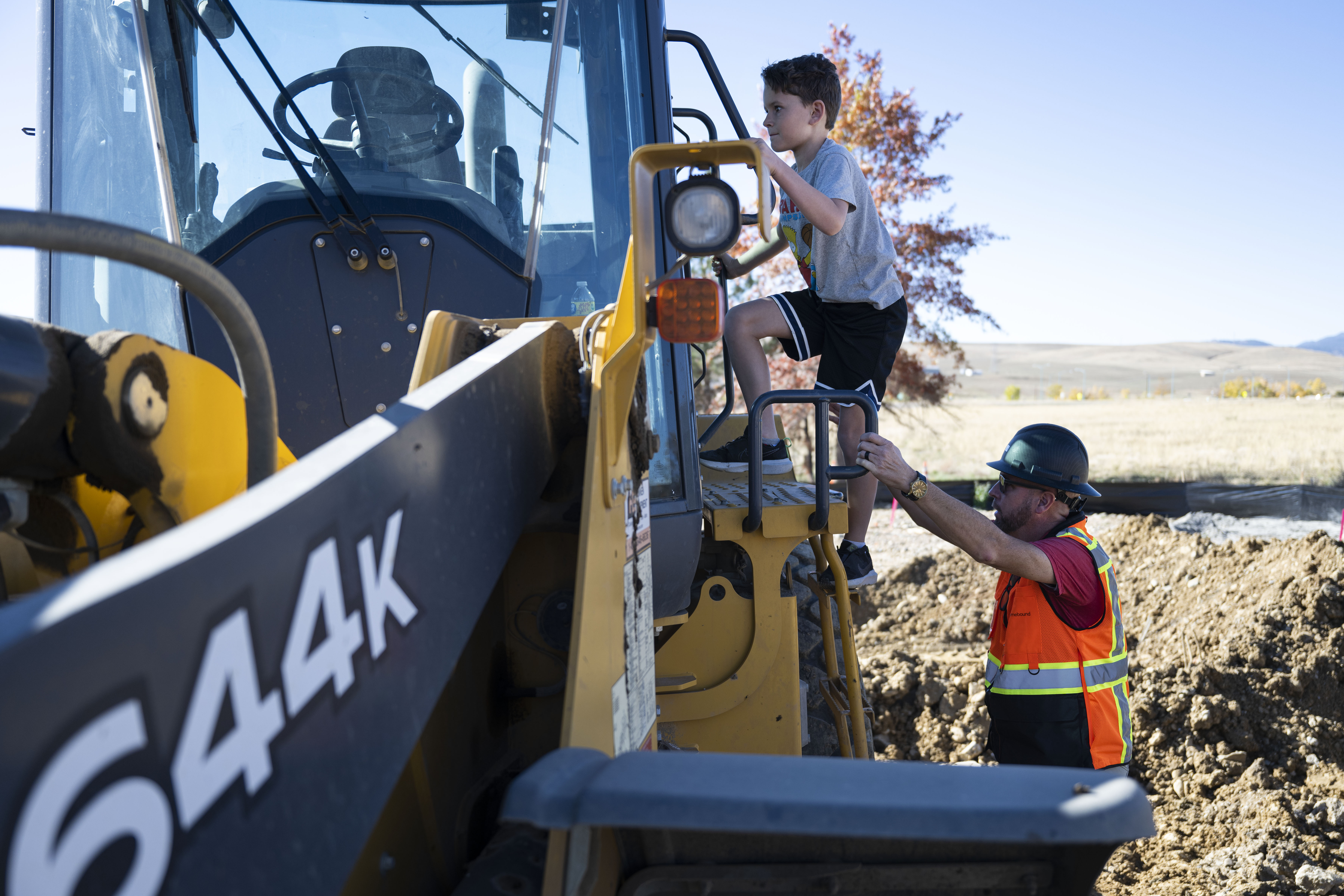 Homebound senior director of construction Chris Stiull helps Collin Cheek, 8, climb into the cab of the bulldozer that will be excavating Cheek’s family’s property to begin rebuilding their home lost in the 2021 Marshall Fire, on Wednesday, Oct. 19, 2022, in Superior, Colo. (Timothy Hurst/The Gazette) (TimHursttim.hurst@gazette.comhttps://secure.gravatar.com/avatar/aca82bd62b4ee425c598527cd6faa1b1?d=mm&r=g)