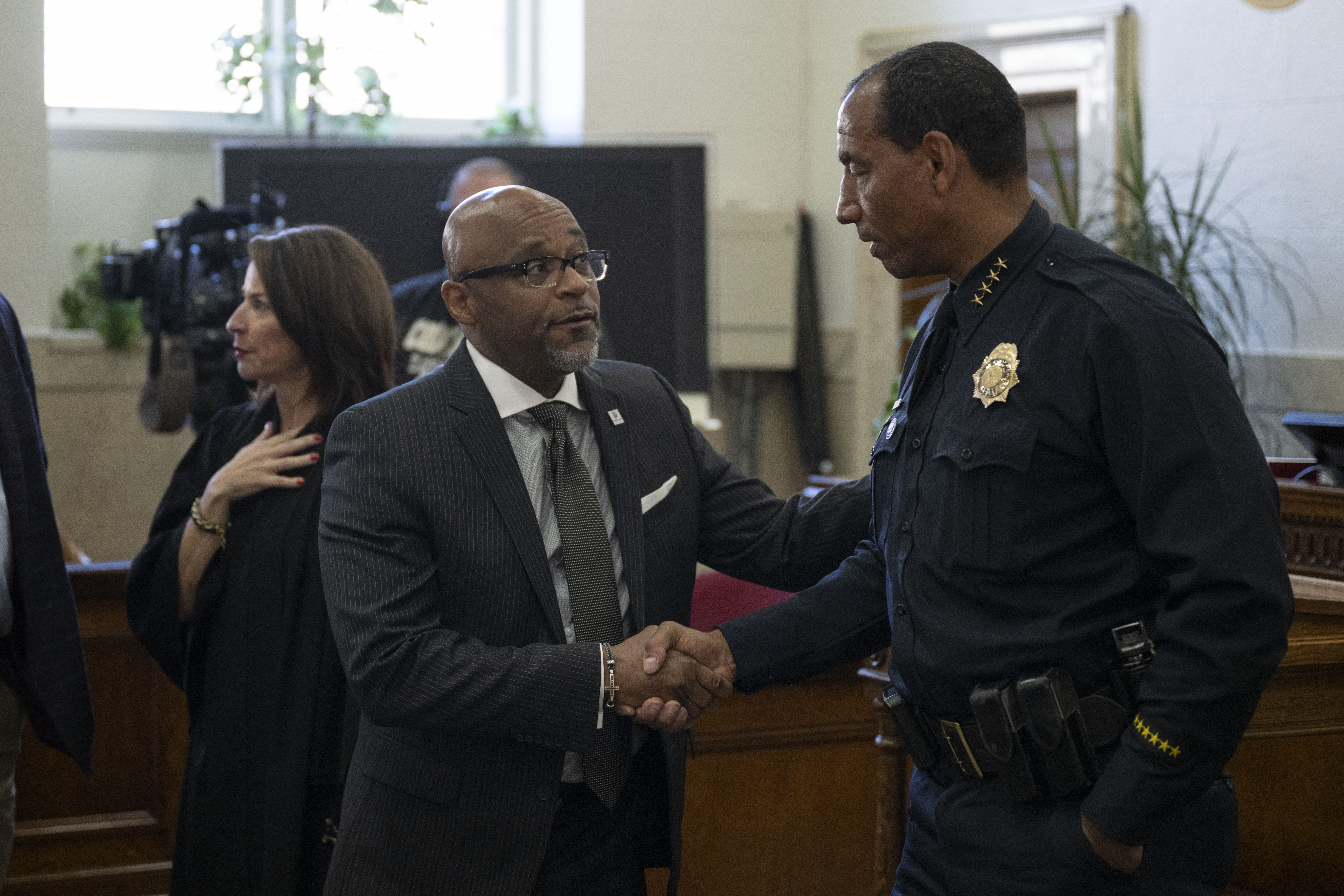 Denver mayor Michael Hancock shakes hands with newly sworn in Denver Police Department chief of police Ron Thomas on Tuesday, Oct. 18, 2022, at the Denver City and County Building in Denver, Colo. (Timothy Hurst/The Gazette) (TIMOTHY HURST/DENVER GAZETTE)