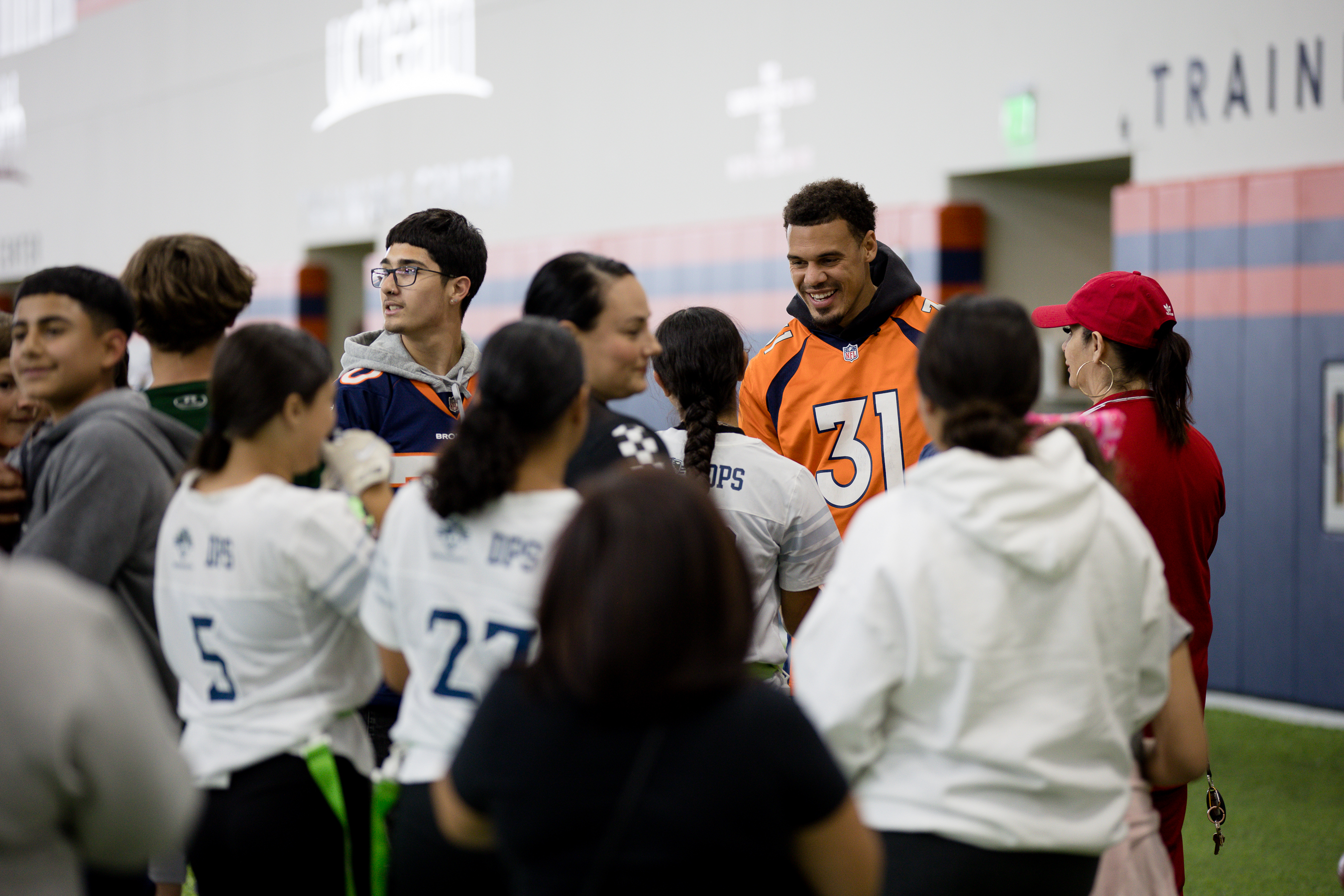 Denver Bronco Justin Simmons greets fans and stops for photos Saturday during the Girl's High School Flag football Championship tournament. (Sara Hertwig/for The Denver Gazette)