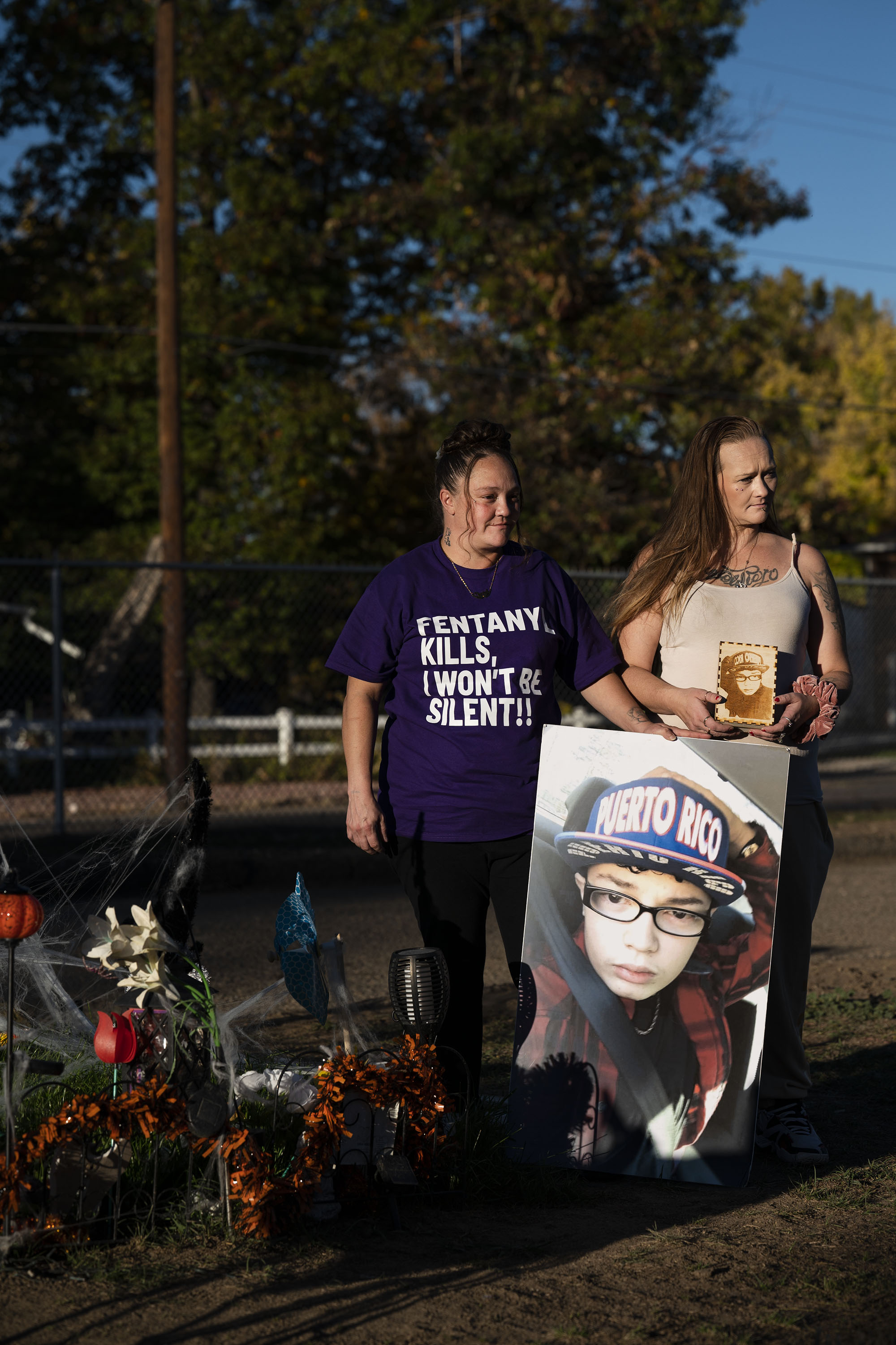 Christina Luna, the mother of Josiah Velasquez, left, and her close friend and sister Tara Garcia stand for a photo while spending time at Josiah’s grave that’s been decorated for Halloween on Thursday, Oct. 20, 2022, at the Crown Hill Cemetery in Lakewood, Colo. Luna and Garcia visit the site often and bring a large photo of Josiah with them each time they visit. (Timothy Hurst/The Gazette) (TimHursttim.hurst@gazette.comhttps://secure.gravatar.com/avatar/aca82bd62b4ee425c598527cd6faa1b1?d=mm&r=g)