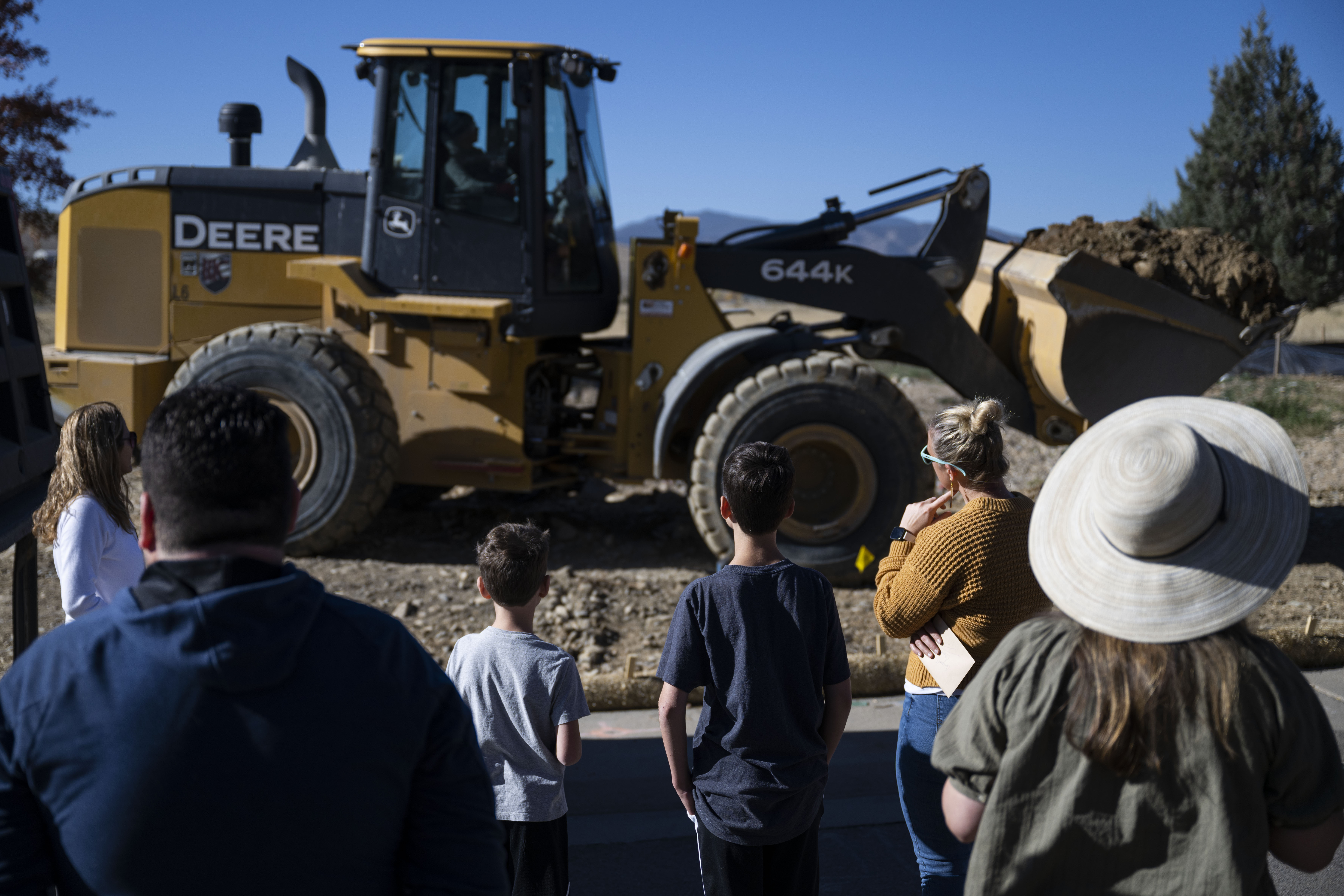The Cheek family and multiple neighbors watch as a bulldozer excavates their property to begin building their new home, replacing their home lost in the Marshall Fire of 2021, on Wednesday, Oct. 19, 2022, in Superior, Colo. (Timothy Hurst/The Gazette) (TimHursttim.hurst@gazette.comhttps://secure.gravatar.com/avatar/aca82bd62b4ee425c598527cd6faa1b1?d=mm&r=g)