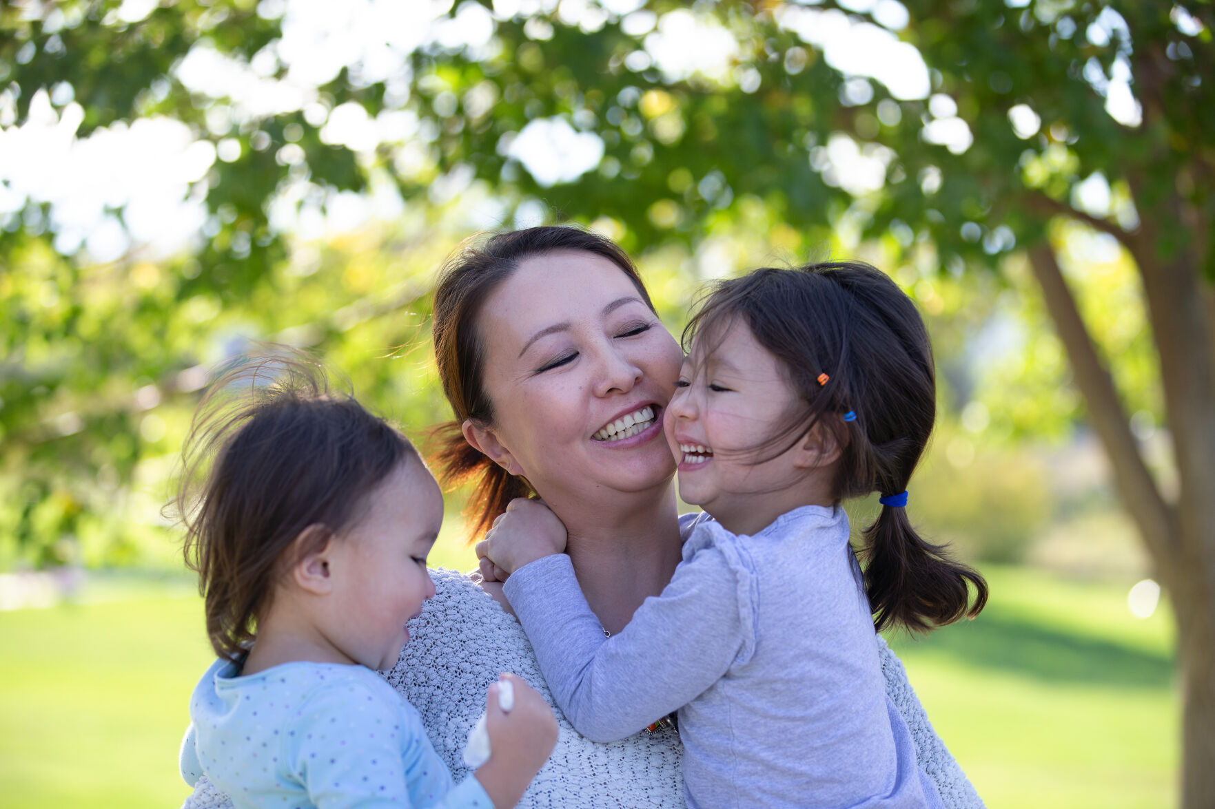 Jing Tesoriero plays with her daughters Chloe, 4, and Tylee Holberger, 2, last week at Highland Hollows Park in Aurora. (Liz Copan, special to the gazette)