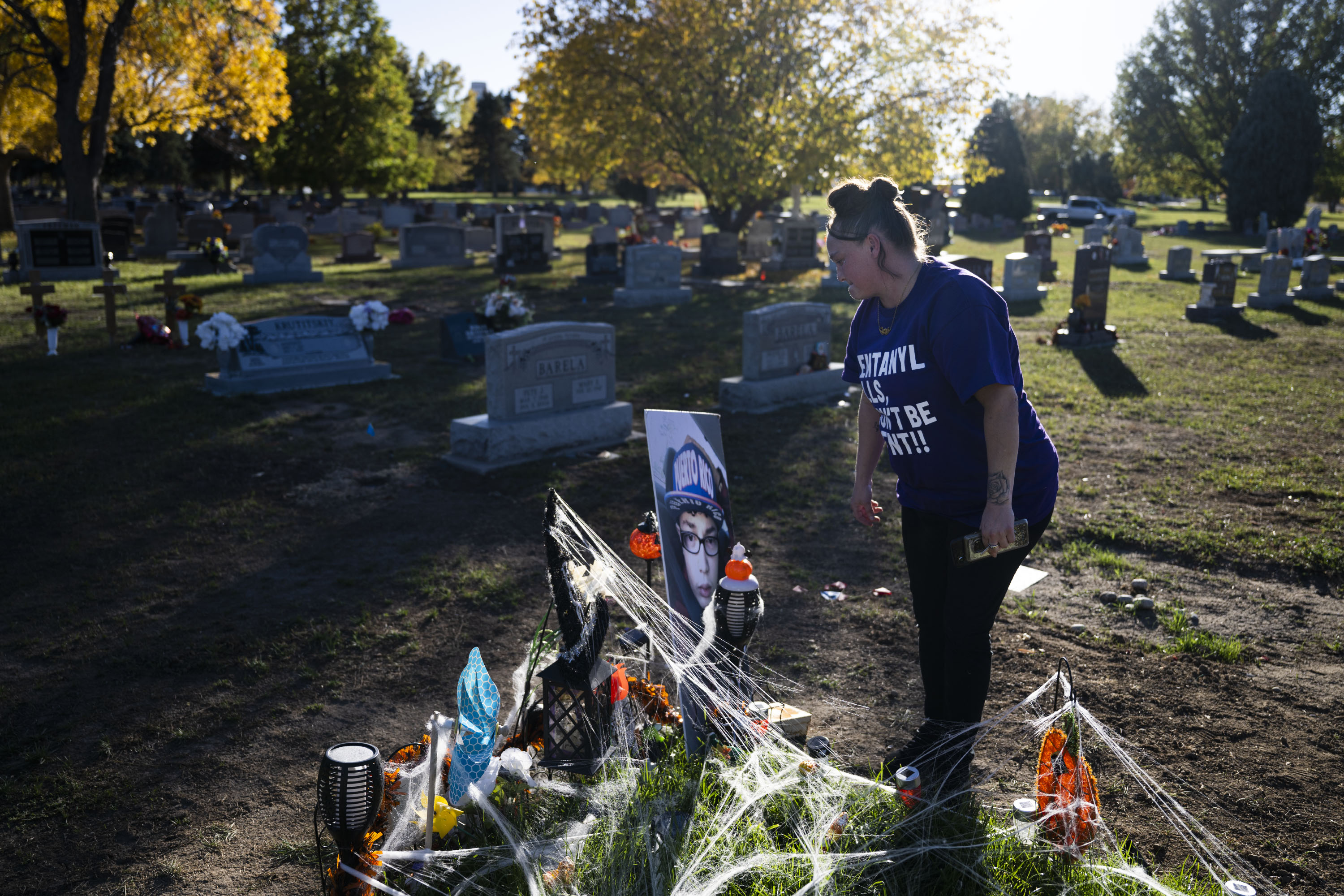 Christina Luna, the mother of Josiah Velasquez, looks at the large photo of Josiah she brings with her each time she visits his grave on Thursday, Oct. 20, 2022, at the Crown Hill Cemetery in Lakewood, Colo. Luna and her close friend and sister Tara Garcia visit the grave multiple times a week and decorate the site, care for the grass they planted and decorate it for the upcoming holiday. (Timothy Hurst/The Gazette) (TimHursttim.hurst@gazette.comhttps://secure.gravatar.com/avatar/aca82bd62b4ee425c598527cd6faa1b1?d=mm&r=g)