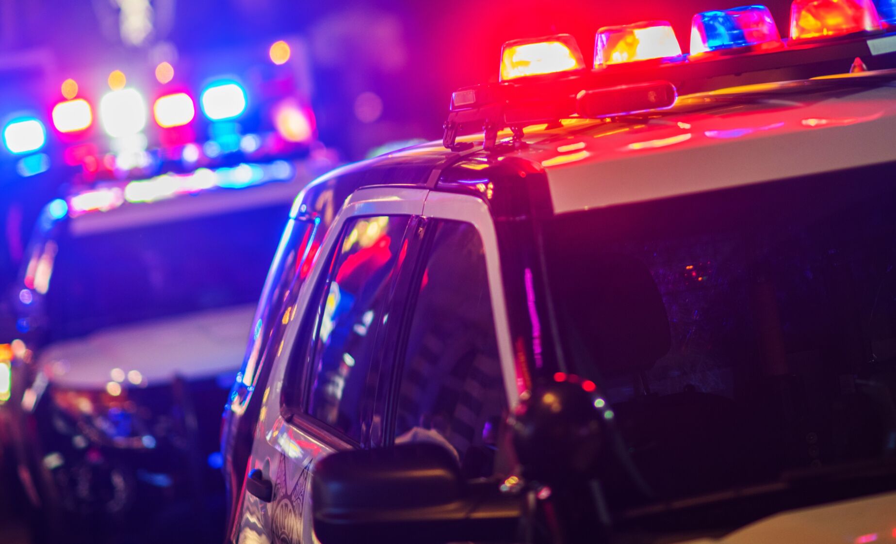 Night Time Police Violent Crime Intervention. Police Vehicles with Flashing Lights. (welcomia)