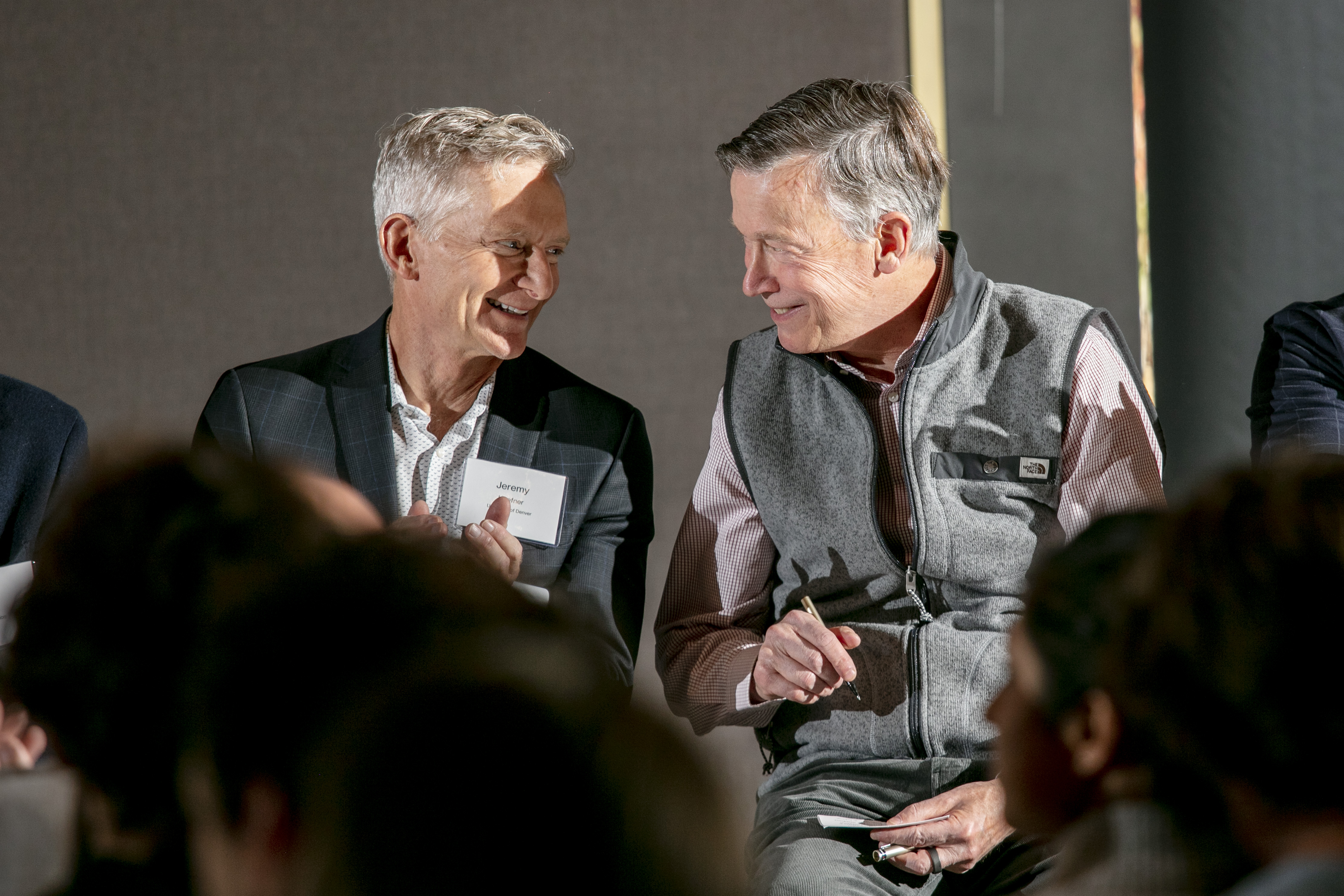 University of Denver(DU) Chancellor Jeremy Haefner, left, and U.S. Senator John Hickenlooper (D-Colo.) chat during a ceremony to unveil the Leadership in Outdoor Recreation Industry Oct. 31, 2022. (COURTESY OF THE UNIVERSITY OF DENVER/BEAR GUTIERREZ)
