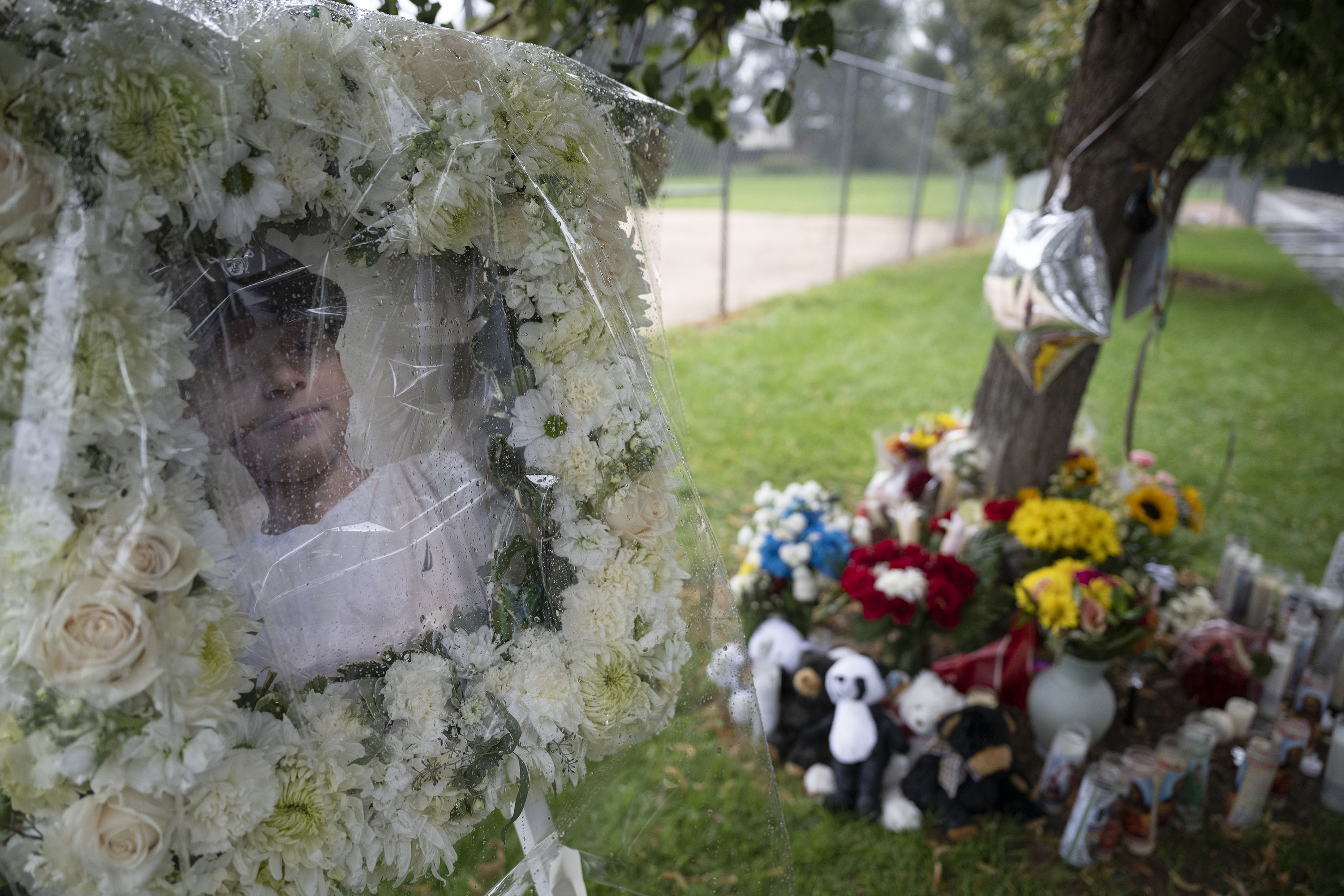 A photograph of Josiaz “JoJo” Aragon, a 14-year-old who was killed Aug. 8, 2022, with his body found near the baseball field at the Southwest Recreation Center, sits in front of the memorial as friends and family gather for a candle-lit vigil on Monday, August 15, 2022, in Denver, Colo.(Timothy Hurst/The Denver Gazette) (TimHursttim.hurst@gazette.comhttps://secure.gravatar.com/avatar/aca82bd62b4ee425c598527cd6faa1b1?d=mm&r=g)