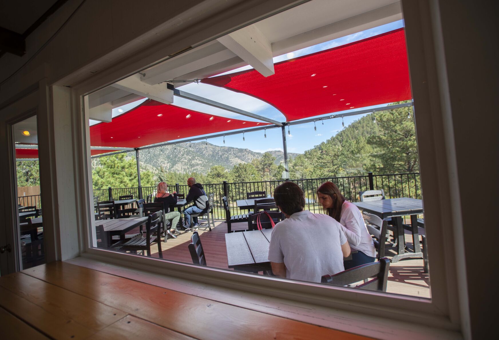 Customers sit on the deck outside Colorado Cherry Co. on Highway 36 between Estes Park and Lyons, Colo., Tuesday, Sept. 27, 2022. (The Gazette, Christian Murdock) (Christian Murdock/The Gazette)