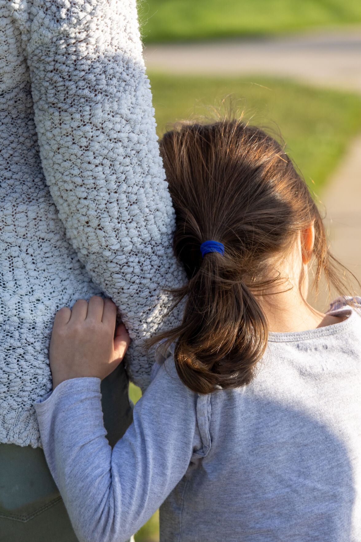 Jing Tesoriero comforts her daughter this month at Highland Hollows Park in Aurora. (Liz Copan, special to the gazette)