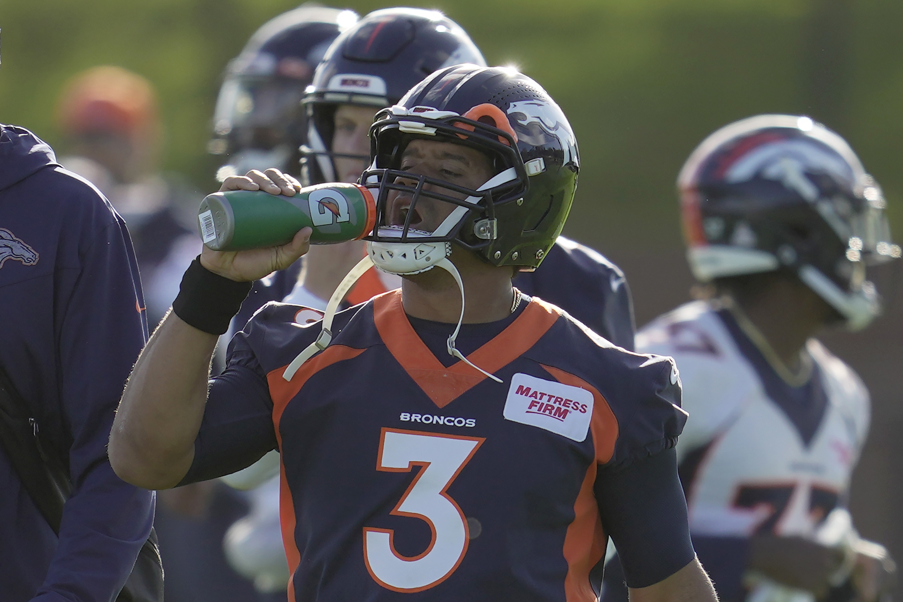 Denver Broncos quarterback Russell Wilson drinks during a practice session in Harrow, England, Wednesday, Oct. 26, 2022 ahead the NFL game against Jacksonville Jaguars at the Wembley stadium on Sunday. (AP Photo/Kin Cheung) (Kin Cheung)