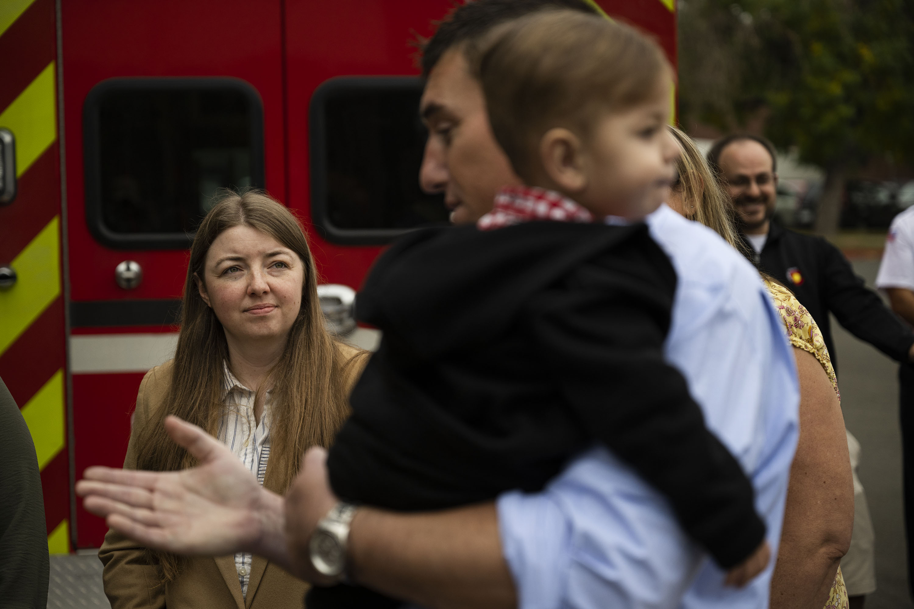 Emergency communications specialist Julie McKay looks on as William Kiernan holds Alexander Thompson, 1, who was saved by his mother Sharon Thompson’s initial CPR when he was found unconscious and not breathing, and later by first responders, after a presentation of the Phoenix Award to Sharon Thompson and those first responders on Tuesday, Oct. 4, 2022, at Aurora Fire Rescue Station 10 in Aurora, Colo. McKay received the call from Thompson and instructed her on how to perform CPR on Alexander before first responders arrived. (Timothy Hurst/The Denver Gazette) (TimHursttim.hurst@gazette.comhttps://secure.gravatar.com/avatar/aca82bd62b4ee425c598527cd6faa1b1?d=mm&r=g)