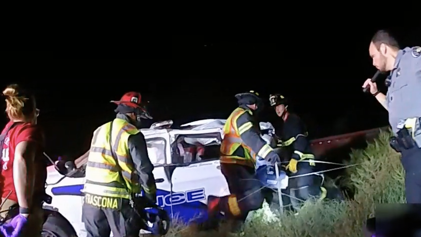 Emergency responders use axes, crowbars and the jaws of life to extricate a suspect trapped in a police car which had just been hit by an oncoming train. The incident happened Sept. 16 at around 7:45 pm just north of Platteville. (Platteville Police Department)