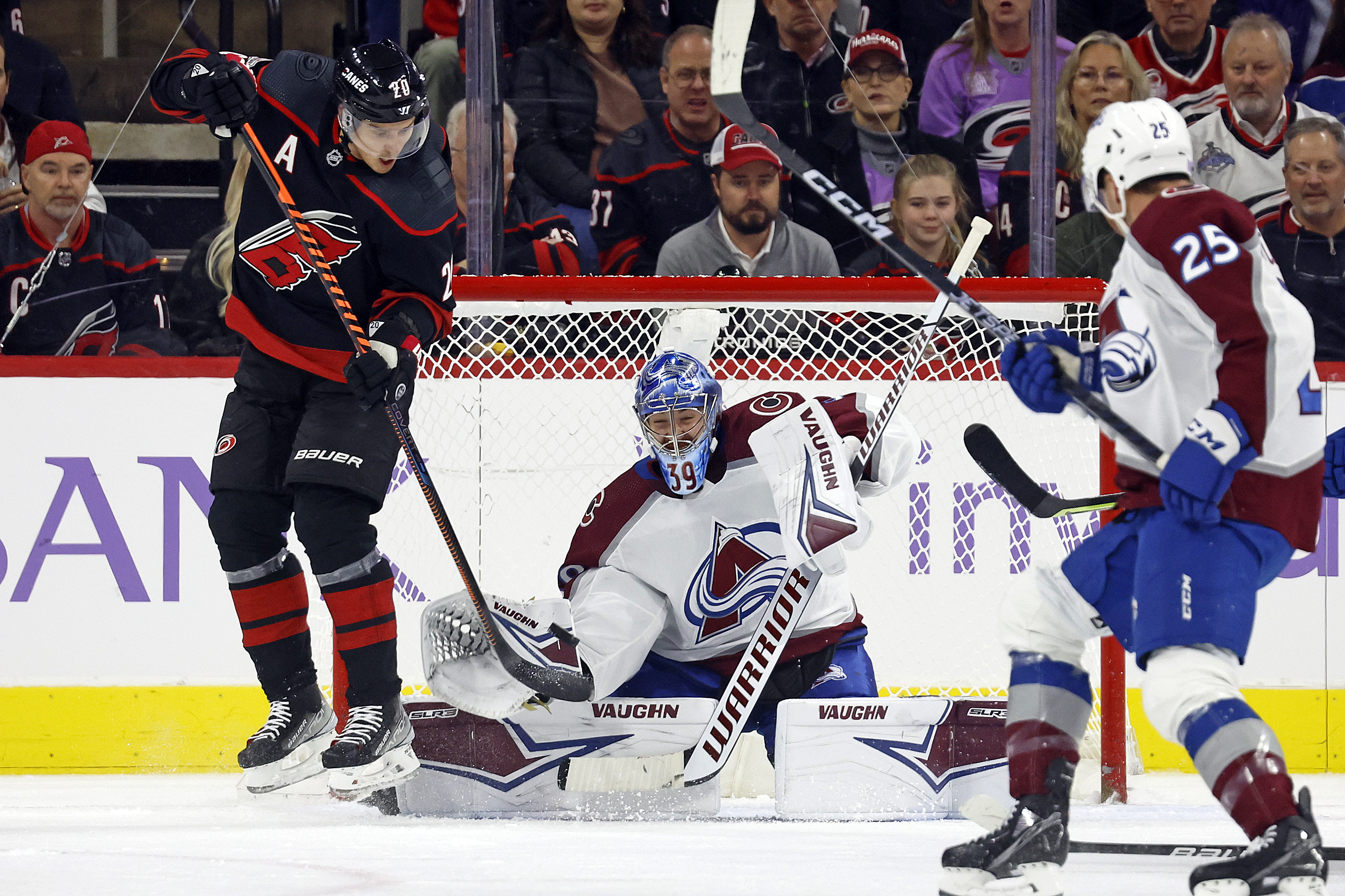 Carolina Hurricanes' Sebastian Aho (20) tries to deflect the puck past Colorado Avalanche goaltender Pavel Francouz (39) during the first period of an NHL hockey game in Raleigh, N.C., Thursday, Nov. 17, 2022. (AP Photo/Karl B DeBlaker) (Karl B DeBlaker)
