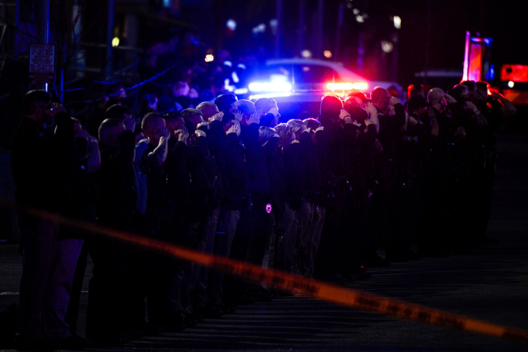 Police officers salute as emergency vehicles prepare to escort the body of slain Boulder Police officer Eric Talley from the scene of a shooting at a King Soopers on Monday, March 22, 2021 in Boulder. Ten people were killed in the shooting. (Michael Ciaglo/Special to The Denver Gazette) (Michael Ciaglo/Special to The De)