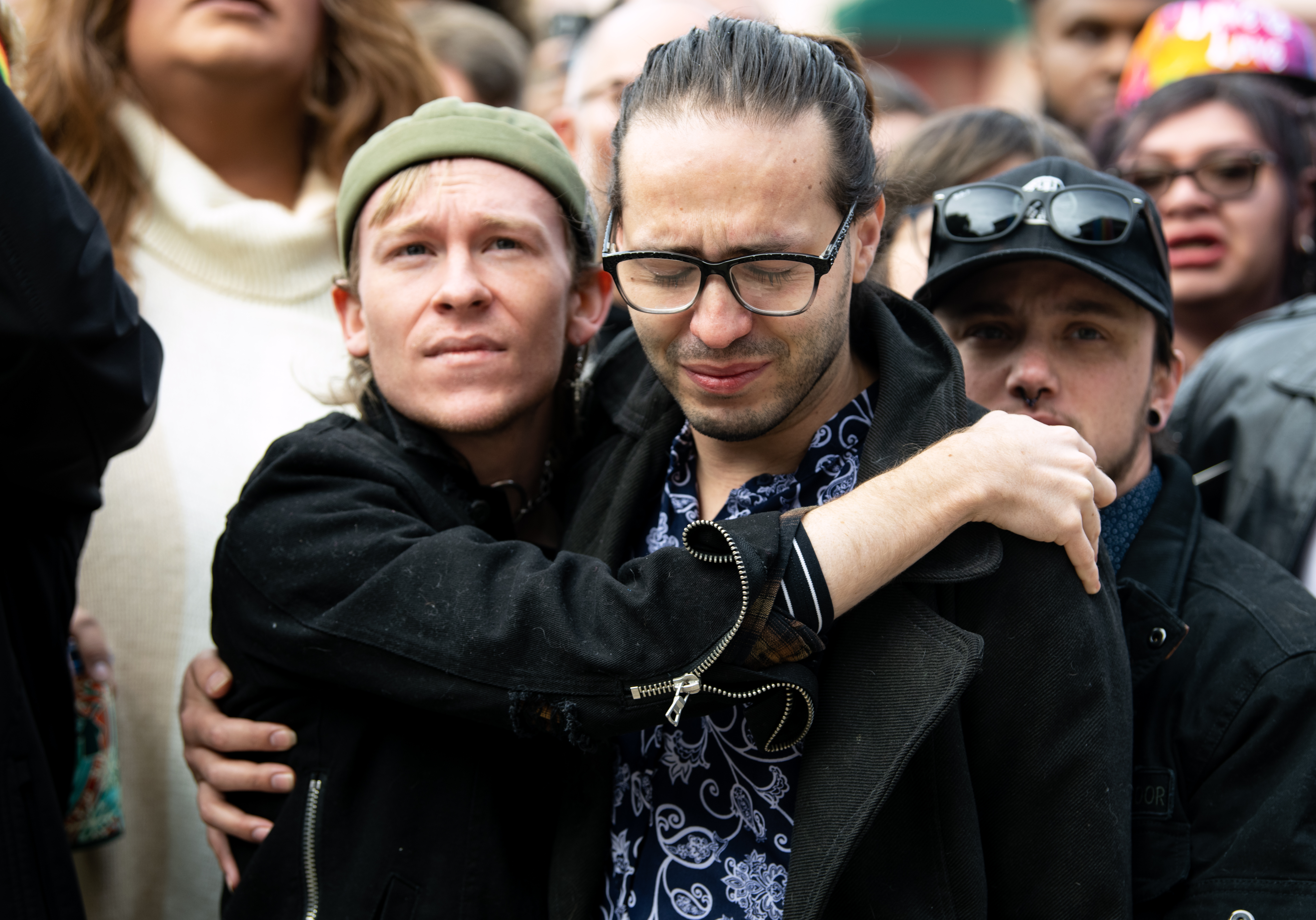 Wyatt Kent, left, the partner of Daniel Aston, one of the victims of the shooting at Club Q, and Autumn Quinn, right, embrace at a ‘Sacred Cloth’ Pride Flag display ceremony at City Hall on Wednesday, Nov. 23, 2022. Kent and Quinn are both drag queens at Club Q. (The Gazette, Parker Seibold) (Parker Seibold)