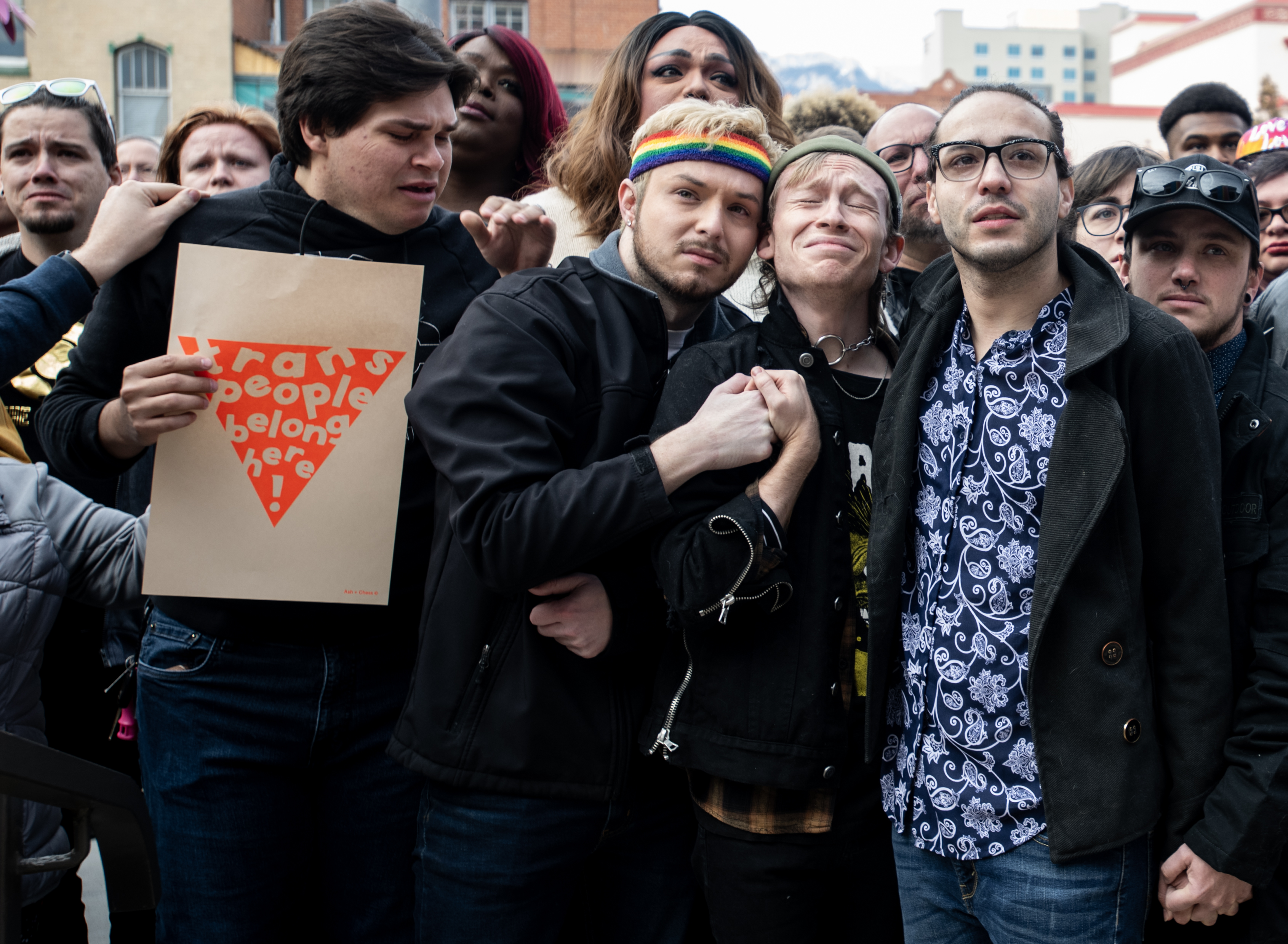 From left, Club Q staff members and performers, Carter Rodriguez, Michael Anderson, Wyatt Kent and Autumn Quinn stand in the front row during a flag ceremony at Colorado Springs City Hall on Wednesday, Nov. 23, 2022. The 25-foot historic pride flag, which has flown at the White House and Pulse nightclub, will stay on city hall for two weeks. (The Gazette, Parker Seibold) (Parker Seibold)