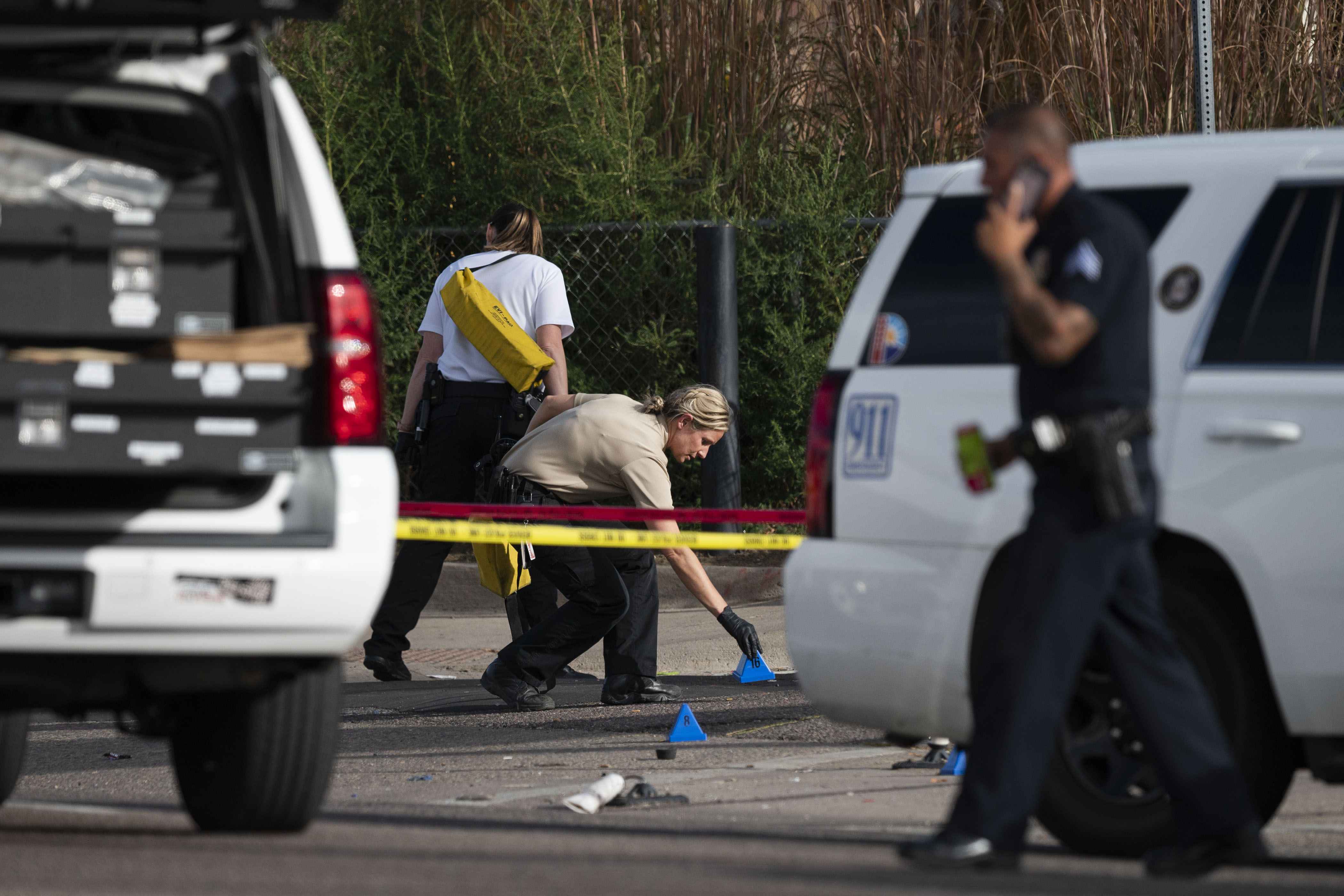 An investigator places evidence placards at the scene of a midday shooting on the 1400 block of Verbena Street, just south of East Colfax Avenue on Tuesday, Nov. 1, 2022, in Denver, Colo. A total of six people were shot on the east side of Michael Convenience Store, with one dying, and three in critical condition as of 5 p.m. (Timothy Hurst/The Gazette) (TimHursttim.hurst@gazette.comhttps://secure.gravatar.com/avatar/aca82bd62b4ee425c598527cd6faa1b1?d=mm&r=g)