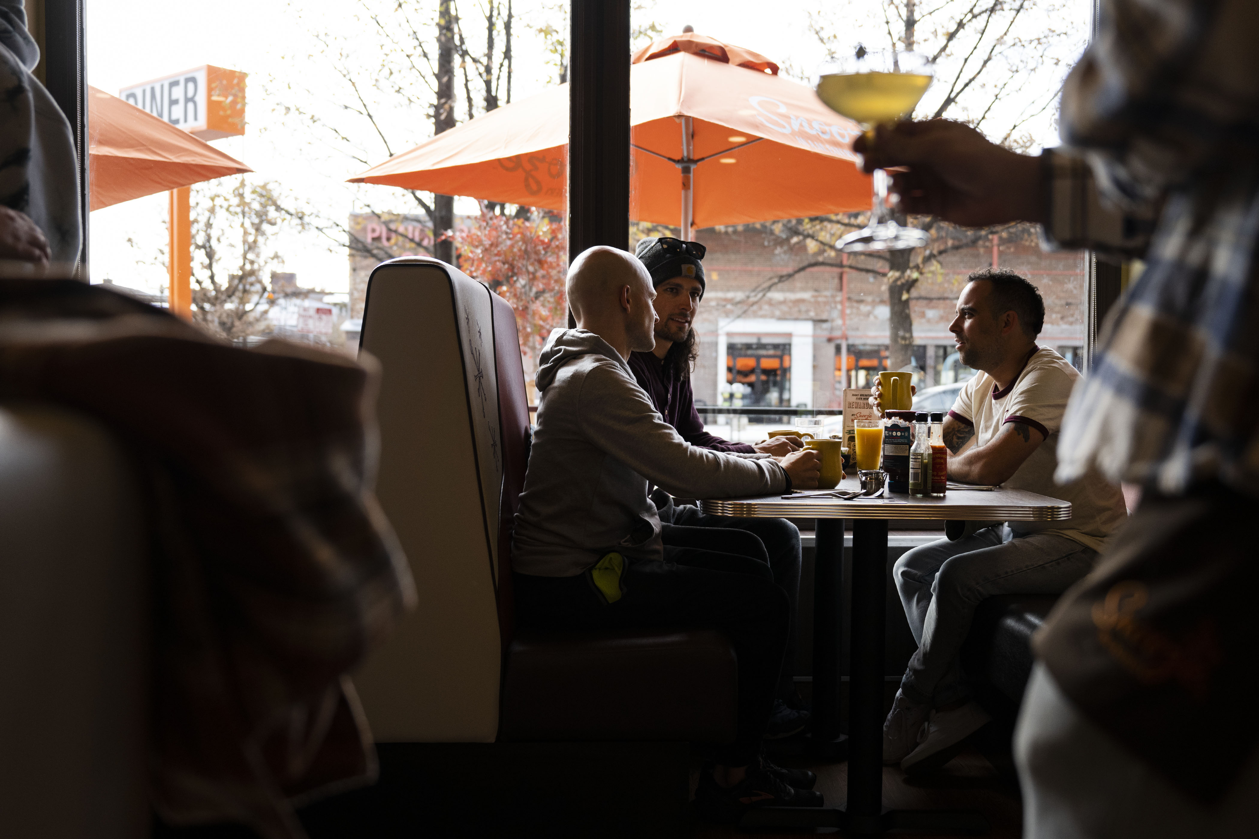 Friends, from left, Shane Kersten, Ian Revo and Luke Gottlieb drink coffee while waiting for their breakfast order Snooze an A.M. Eatery on Wednesday, Nov. 16, 2022, on North Broadway in Denver. (Timothy Hurst/The Gazette) (TimHursttim.hurst@gazette.comhttps://secure.gravatar.com/avatar/aca82bd62b4ee425c598527cd6faa1b1?d=mm&r=g)