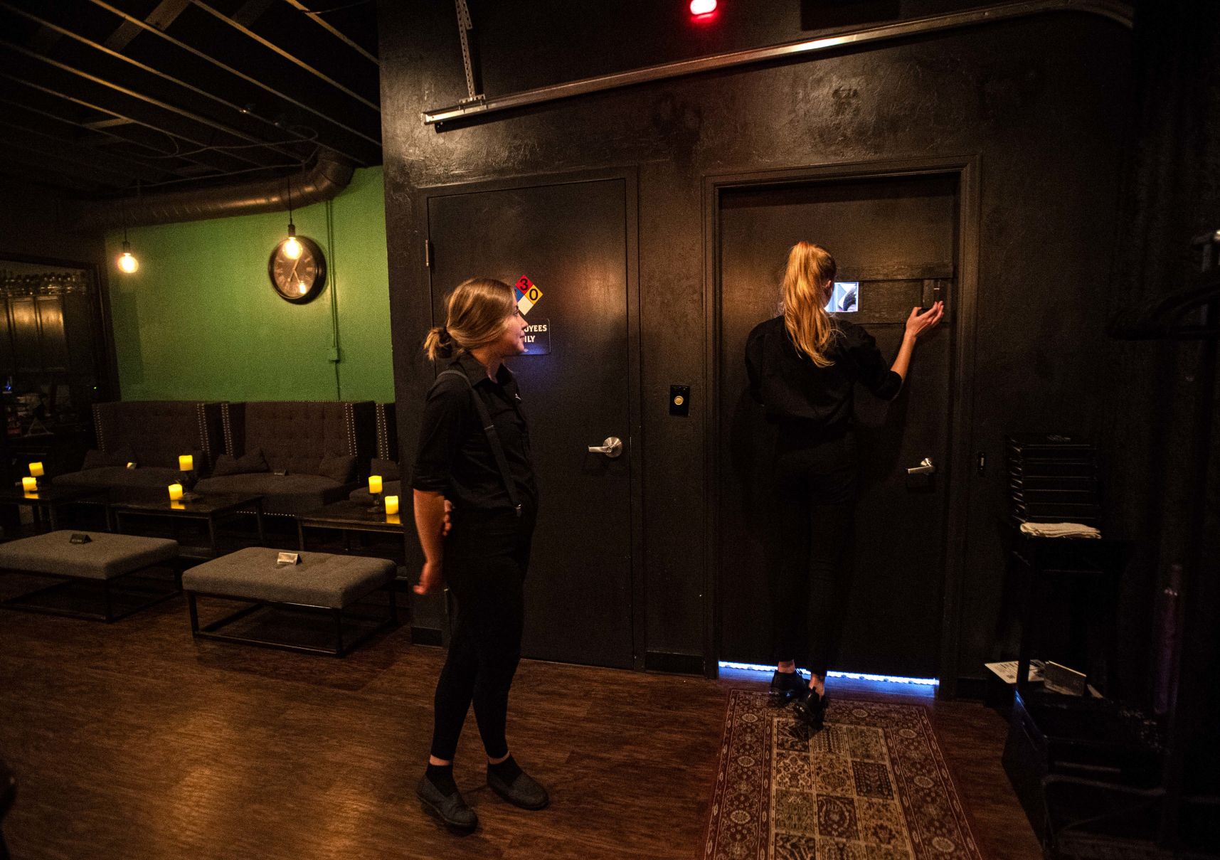 Morgan Keebler, right, checks a patron at the door before letting them in while Robin Jones stands by Friday, Jan. 17, 2020, at Brooklyn’s on Boulder St. in Colorado Springs. The downtown Colorado Springs bar is set up as a speakeasy as if it was the 1920s. (The Gazette, Christian Murdock) (CHRISTIAN MURDOCK/THE GAZETTE)