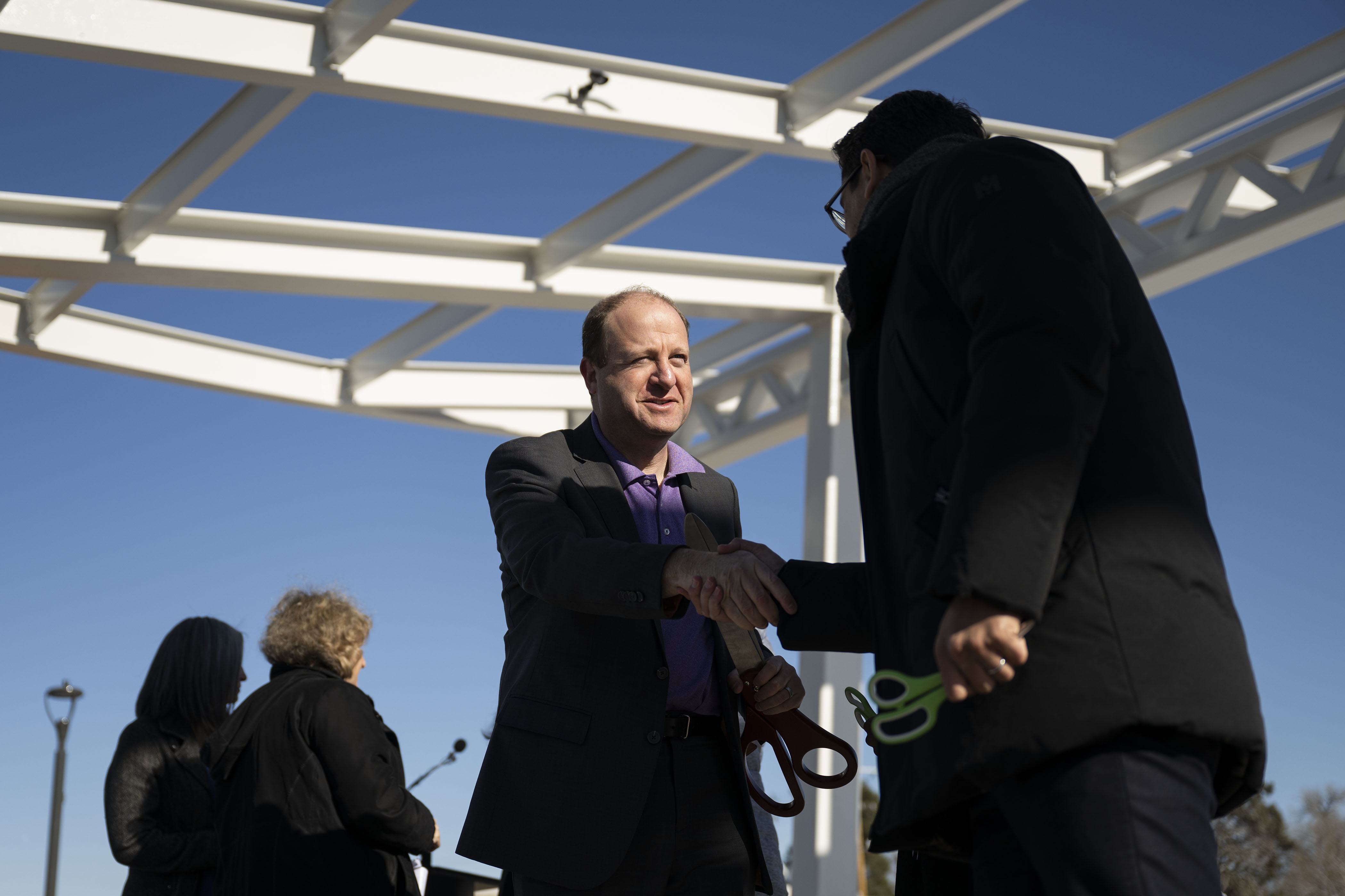 Gov. Jared Polis shakes hands with Meridiam chief operating officer Omri Gainsburg after a ribbon-cutting event to celebrate the opening of the 4-acre Cover Park over Interstate 70 between Brighton Boulevard and Colorado Boulevard on Wednesday, Nov. 30, 2022, in Denver, Colo. (Timothy Hurst/The Gazette) (TimHursttim.hurst@gazette.comhttps://secure.gravatar.com/avatar/aca82bd62b4ee425c598527cd6faa1b1?d=mm&r=g)