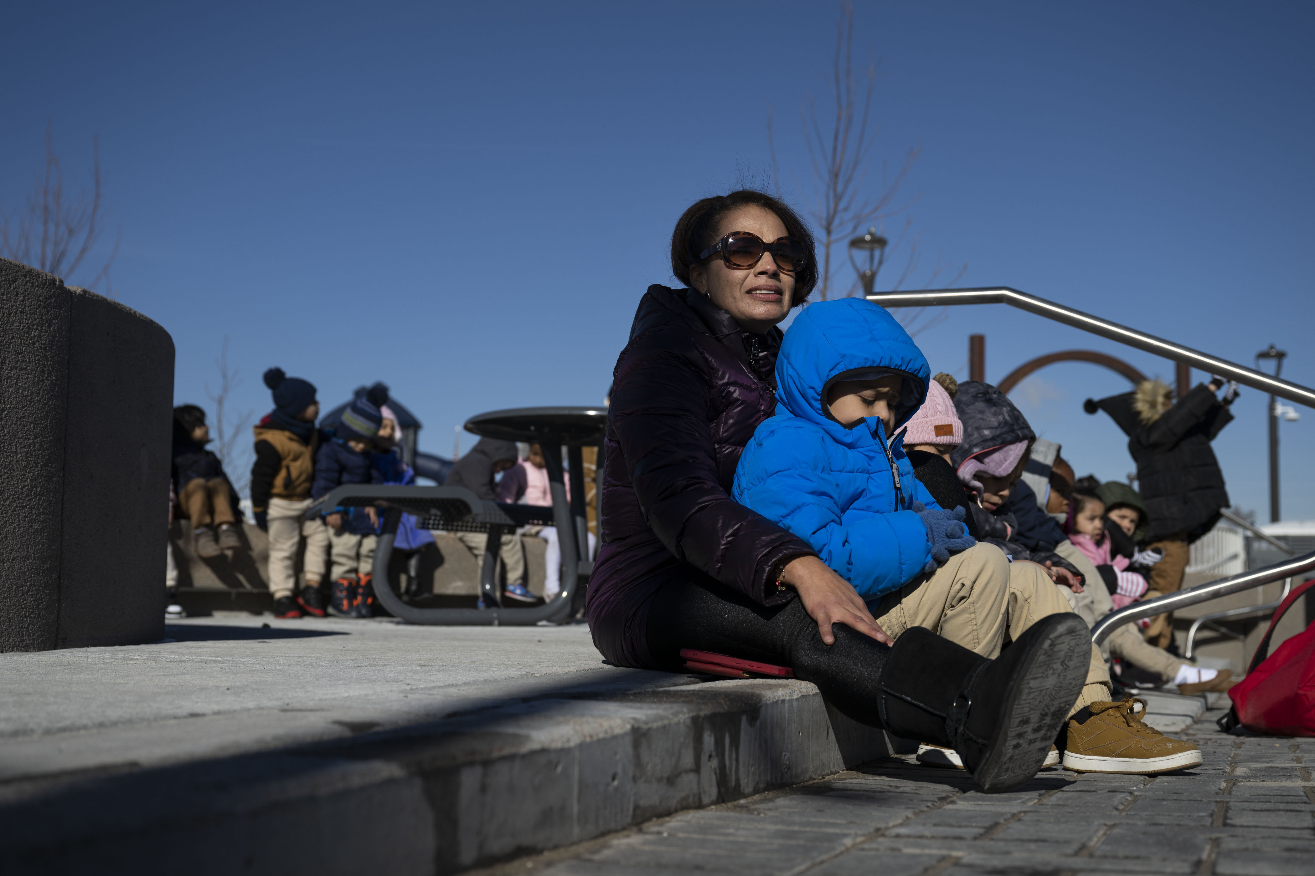 Swansea Elementary School preschool teacher Vanessa Medina watches mayor Michael Hancock speak while sitting with Azaiah Gomez and the rest of her class during a ribbon-cutting event to celebrate the opening of the 4-acre Cover Park over Interstate 70 between Brighton Boulevard and Colorado Boulevard on Wednesday, Nov. 30, 2022, in Denver, Colo. (Timothy Hurst/The Gazette) (TimHursttim.hurst@gazette.comhttps://secure.gravatar.com/avatar/aca82bd62b4ee425c598527cd6faa1b1?d=mm&r=g)