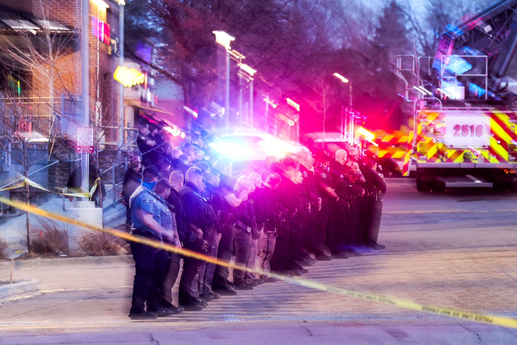 Police officers salute as emergency vehicles prepare to escort the body of slain Boulder Police officer Eric Talley from the scene of a shooting at a King Soopers on Monday, March 22, 2021 in Boulder. Ten people were killed in the shooting. (Michael Ciaglo/Special to The Denver Gazette) (Michael Ciaglo/Special to The De)