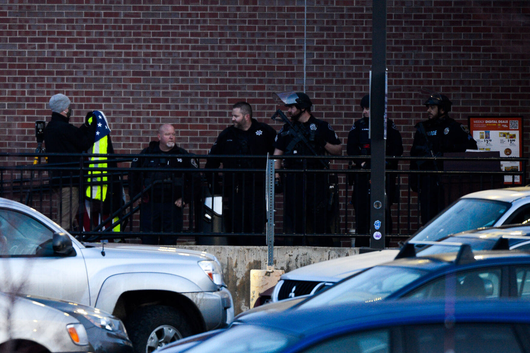 Police officers prepare to drape an American flag over the body of slain Boulder Police officer Eric Talley at the scene of a shooting at a King Soopers on Monday, March 22, 2021 in Boulder. Ten people were killed in the shooting. (Michael Ciaglo/Special to The Denver Gazette) (Michael Ciaglo/Special to The De)