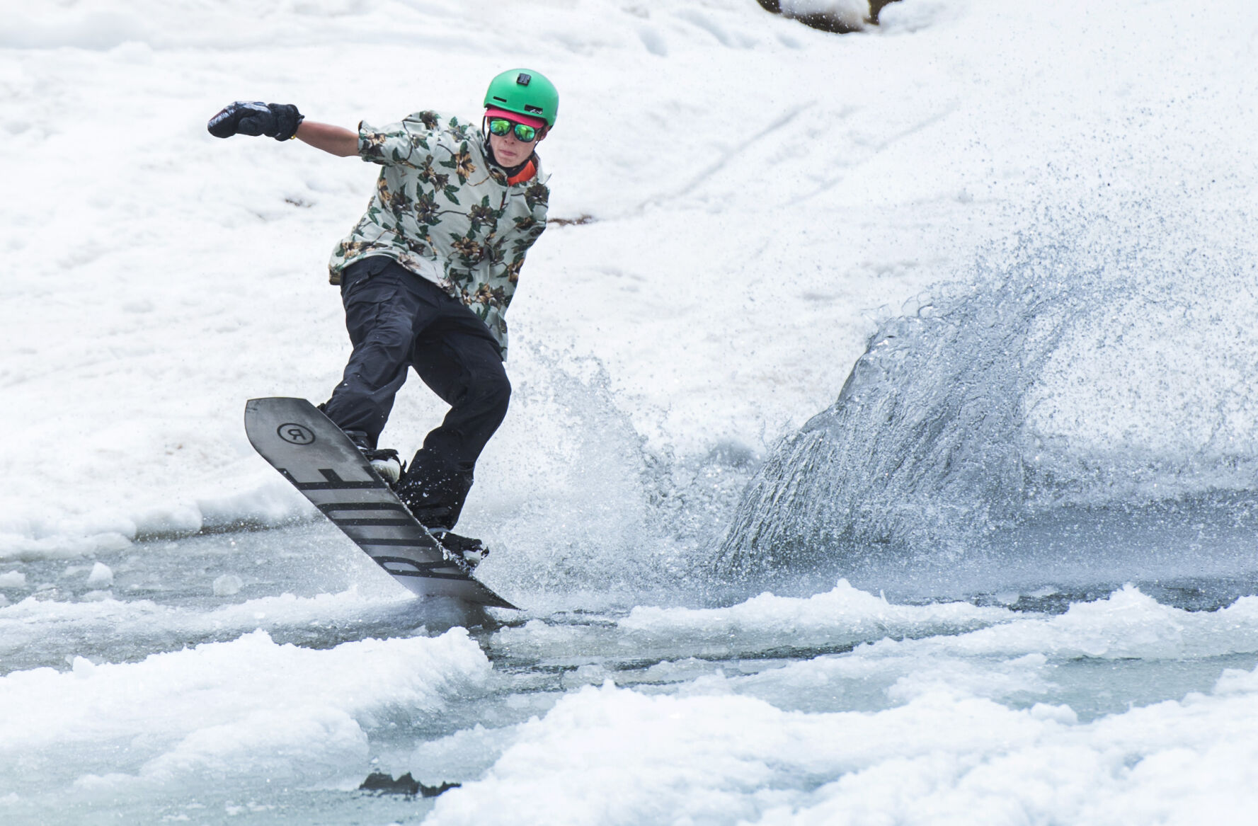 A snowboarder skims across the pond Sunday, June 3, 2018, on the final day of the 2017-2018 ski season at Arapahoe Basin ski area. A-basin was the first ski area in Colorado to open and the last one. (The Gazette, Christian Murdock) (CHRISTIAN MURDOCK THE GAZETTE)