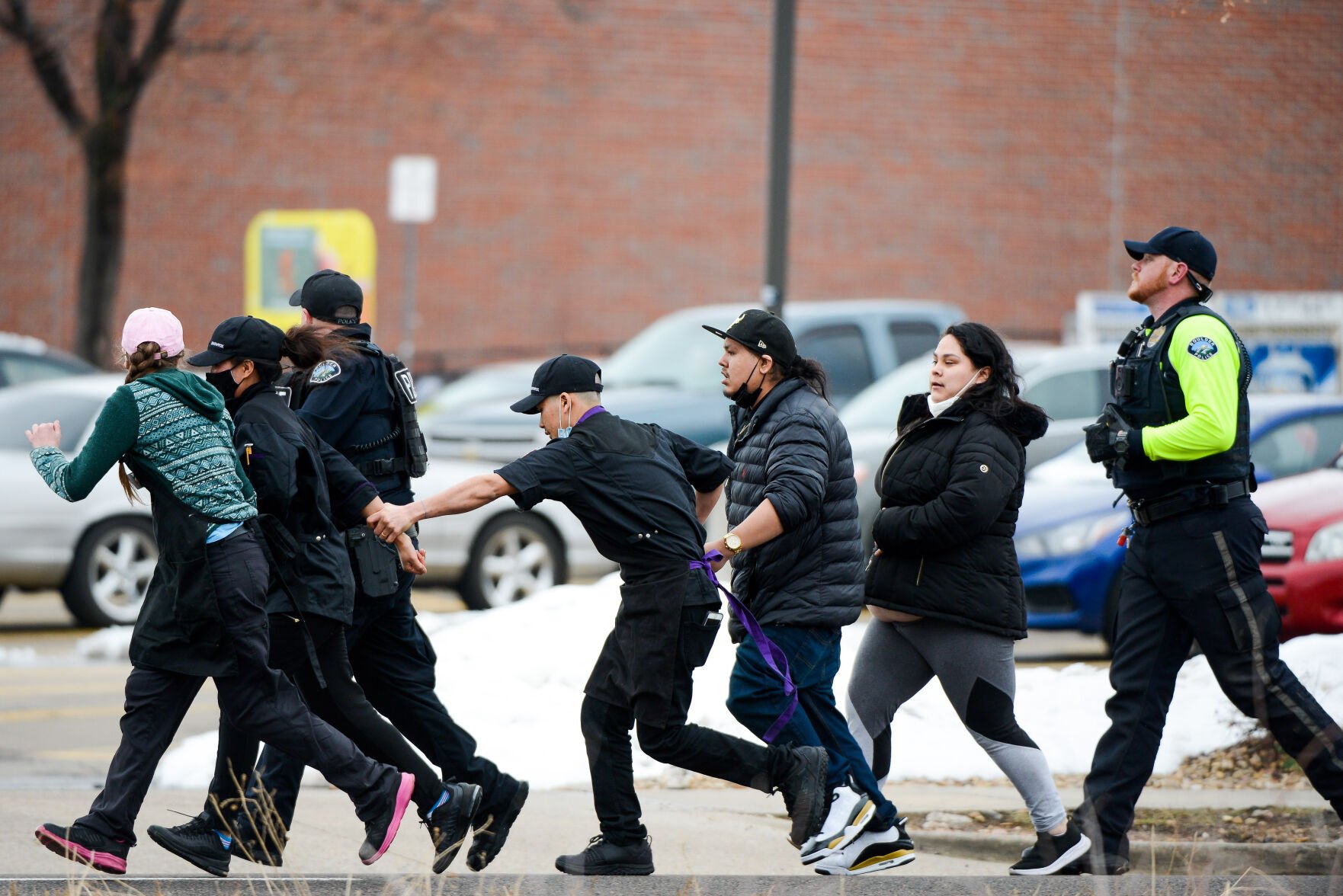Police officers lead a group of King Soopers employees away from an active shooting at the grocery store on Monday, March 22, 2021 in Boulder, Colorado. (Michael Ciaglo/Special to The Denver Gazette) (Michael Ciaglo/Special to The De)