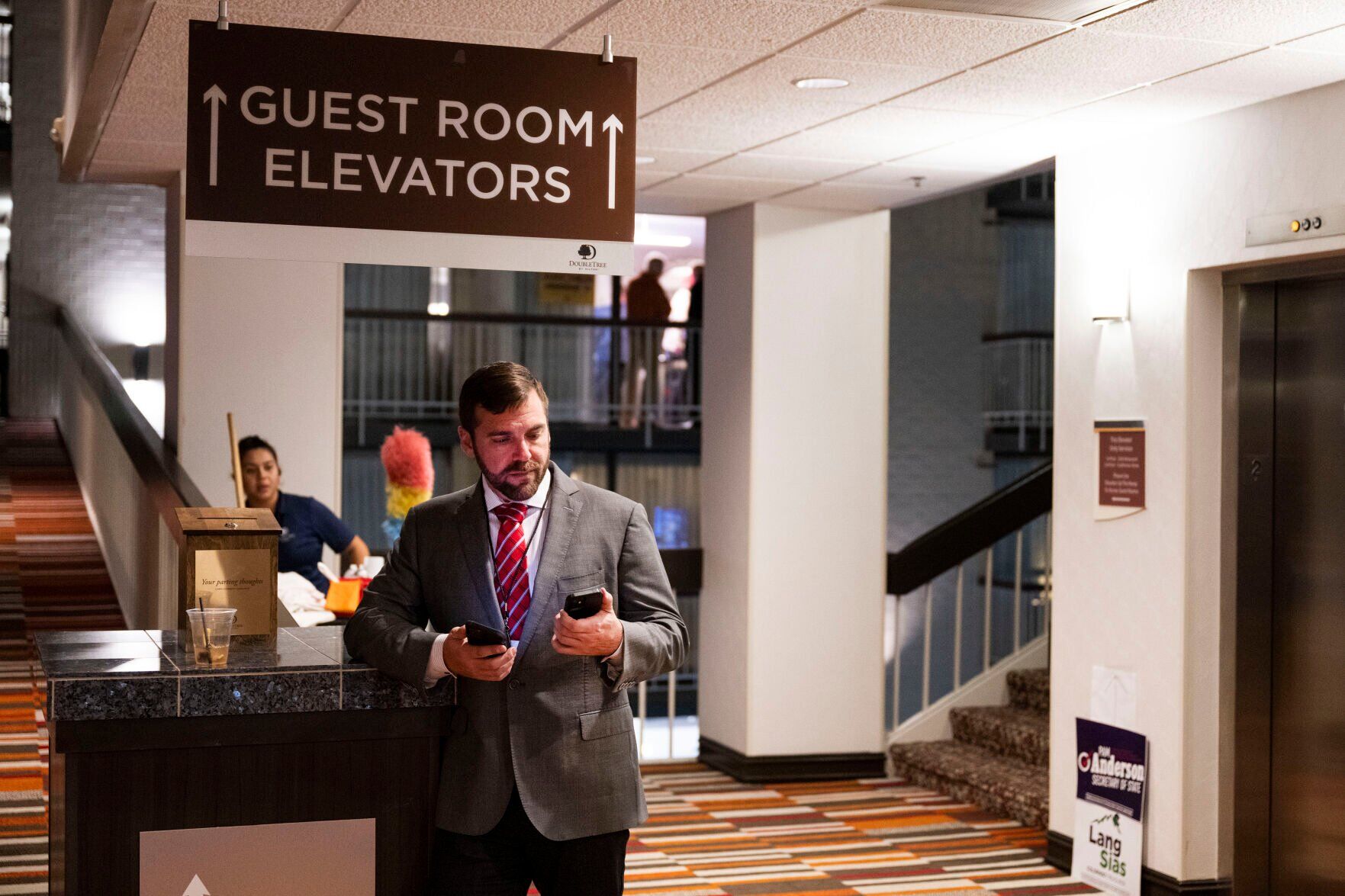 Colorado State Board of Education member candidate Dan Maloit checks two phones in the hallway during the Colorado GOP Election Night Party on Tuesday, Nov. 8, 2022, at the DoubleTree by Hilton DTC in Greenwood Village, Colo. (Timothy Hurst/The Gazette) (TIMOTHY HURST/DENVER GAZETTE)