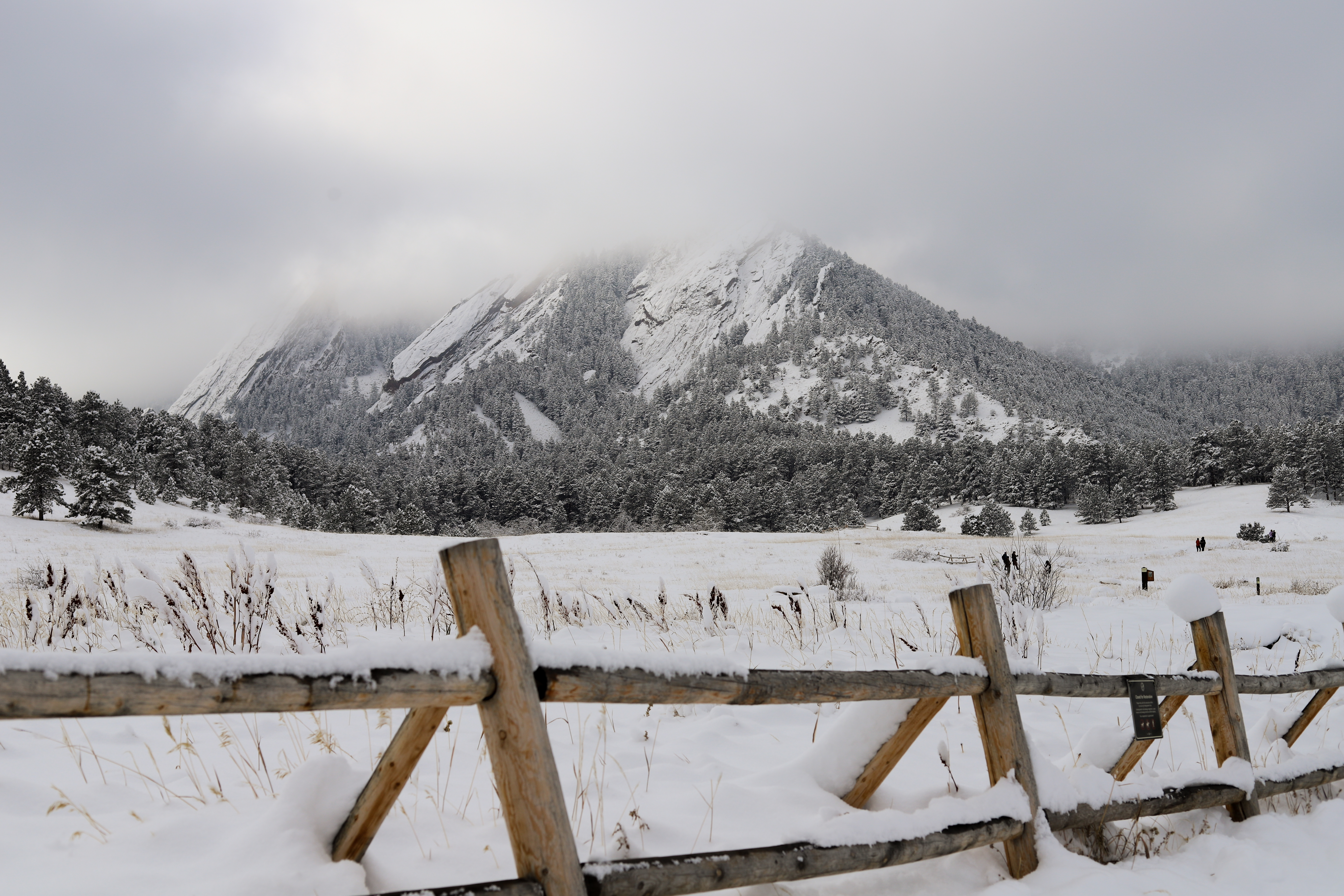 New snow and low clouds cover the Flatirons in Boulder Friday morning. (Kyla Pearce)