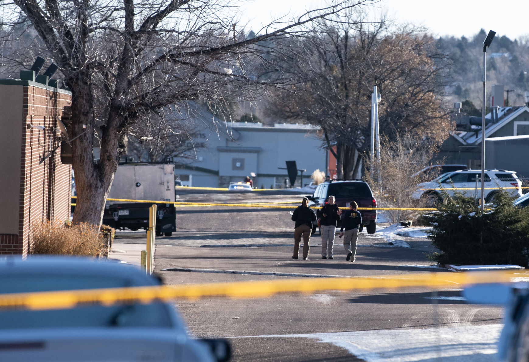 Jace Khosla, right, talks to an officer outside of Club Q where a mass shooting took place late on Saturday, Nov. 19. (The Gazette, Parker Seibold)