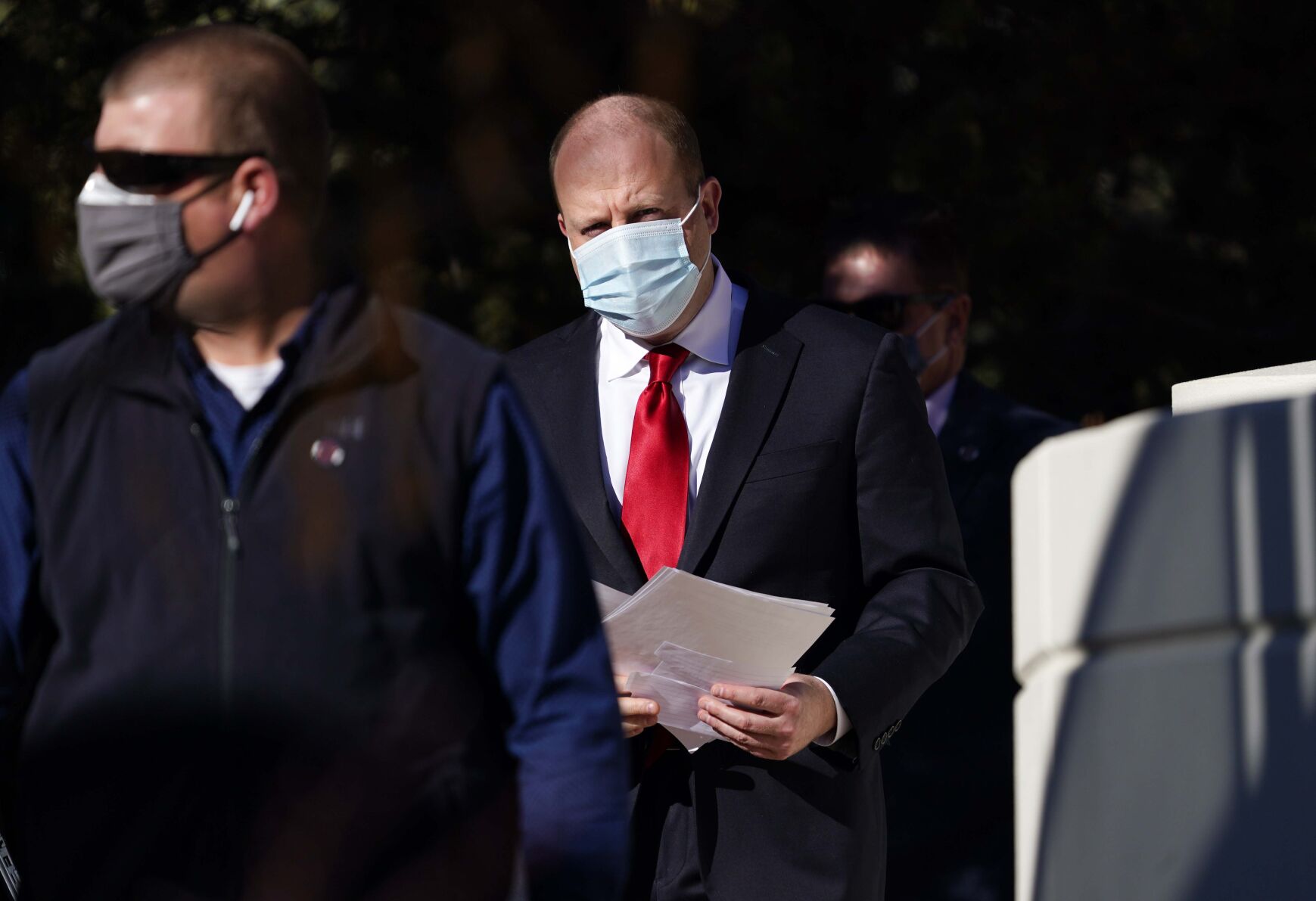 Colorado Gov. Jared Polis, center, wears a face mask as he heads into a news conference to talk about the state's efforts to check the spread of coronavirus Friday, Jan. 15, 2021, in Denver. (AP Photo/David Zalubowski) (David Zalubowski)