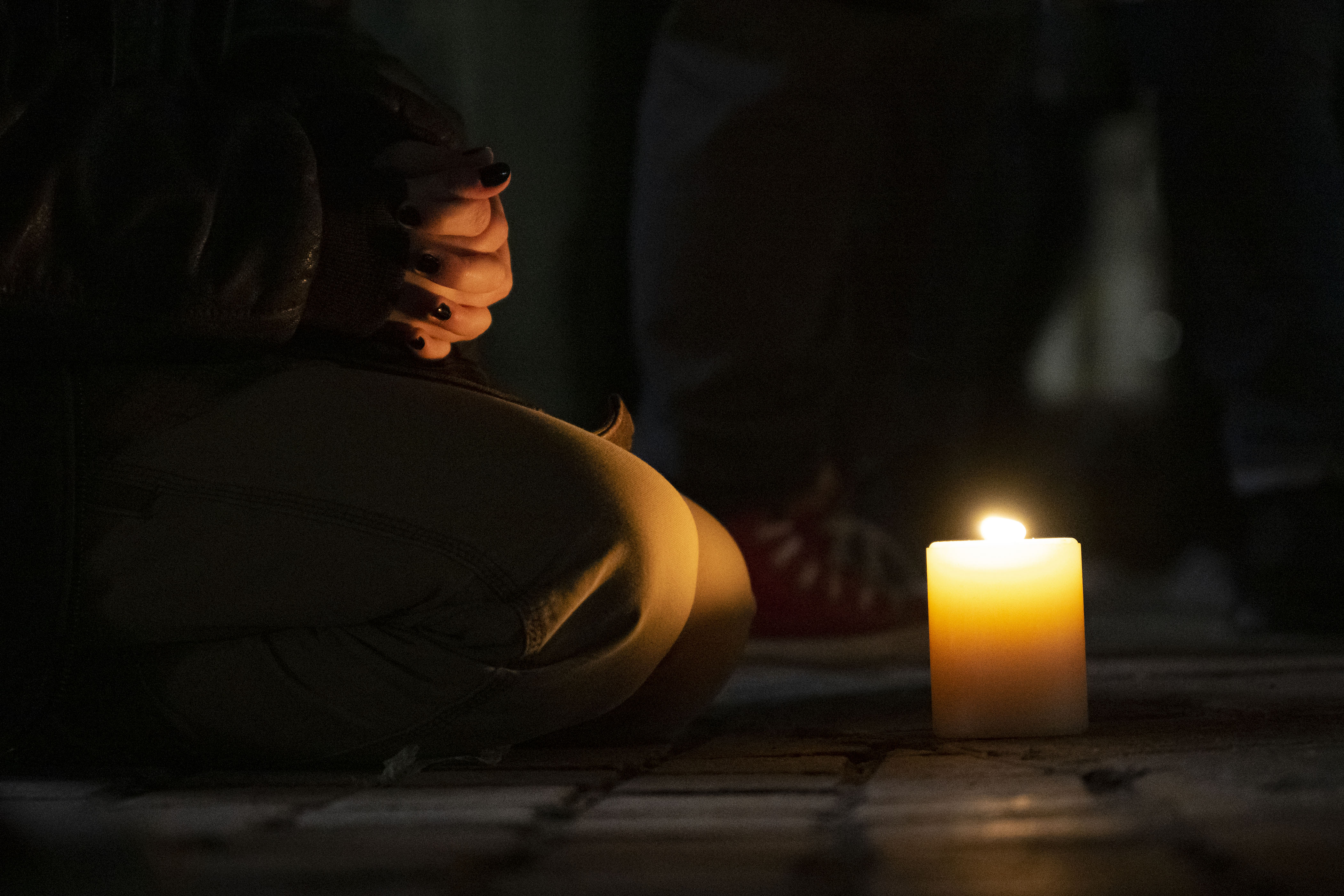 A mourner sits in front of their candle during a vigil in response to a mass shooting at the Colorado Springs LBGTQ+ nightclub Club Q that killed five and injured 17 others just before midnight last Saturday, as seen on Wednesday, Nov. 23, 2022, at the State Capitol Building in Denver, Colo. (Timothy Hurst/The Gazette) (TimHursttim.hurst@gazette.comhttps://secure.gravatar.com/avatar/aca82bd62b4ee425c598527cd6faa1b1?d=mm&r=g)