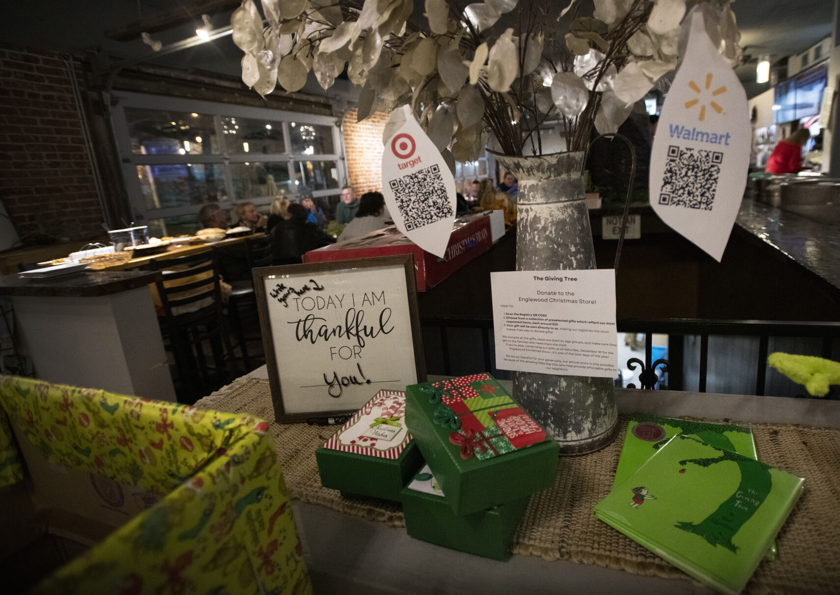 A box for donations to the Englewood Christmas Store greets customers at the entrance to Brewability. (Christian Murdock,The Gazette)