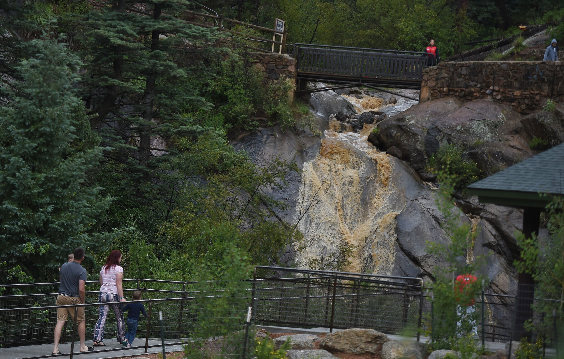 The Ramagli family uses the cement walkway and hand rails at Helen Hunt Falls after an afternoon shower on Thursday, July 1, 2021. (Jerilee Bennett,The Gazette)