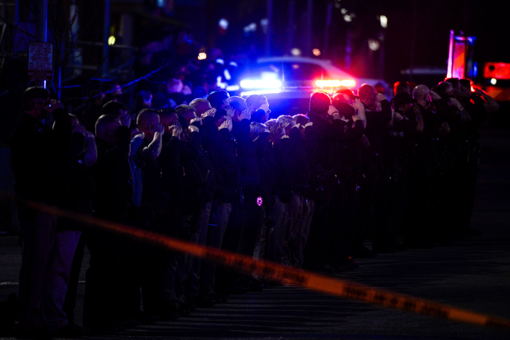 Police officers salute as emergency vehicles prepare to escort the body of slain Boulder Police officer Eric Talley from the scene of a shooting at a King Soopers on Monday, March 22, 2021 in Boulder. Ten people were killed in the shooting. (Michael Ciaglo/Special to The Denver Gazette) (Michael Ciaglo/Special to The De)