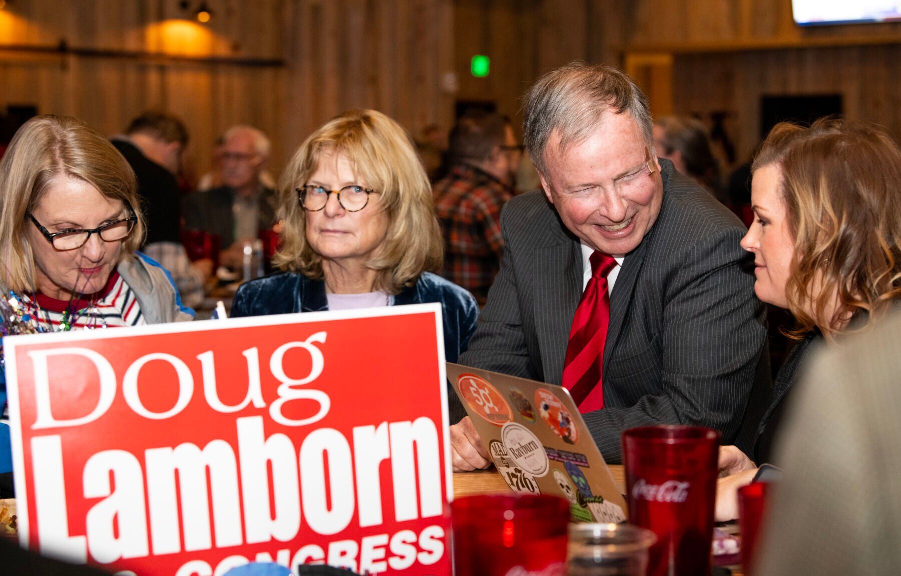 Congressman Doug Lamborn looks at results with his communications director Cassandra Sebastian, right, and his wife Jeanie Lamborn at the El Paso Republican’s election watch party at Boot Barn Hall at Bourbon Brothers on Nov. 8, 2022. (The Gazette, Parker Seibold) (Parker Seibold)