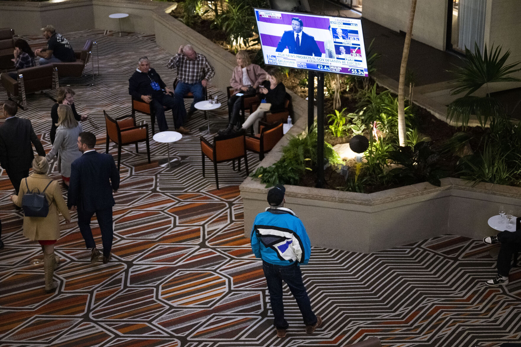 Domenic Rea tunes into live results in the lobby outside the bar during the Colorado GOP Election Night Party on Tuesday, Nov. 8, 2022, at the DoubleTree by Hilton DTC in Greenwood Village, Colo. (Timothy Hurst/The Gazette) (TIMOTHY HURST/DENVER GAZETTE)