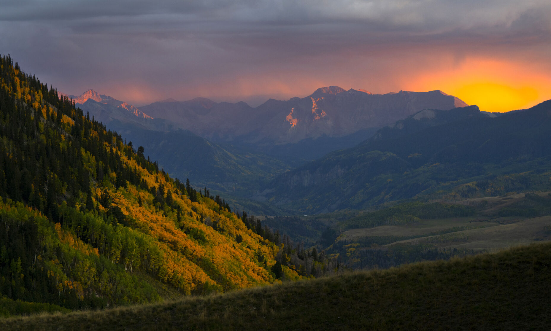 The setting sun paints the sky red as a storm hits the San Juan Mountains near Telluride. (Christian Murdock, The denver Gazette)