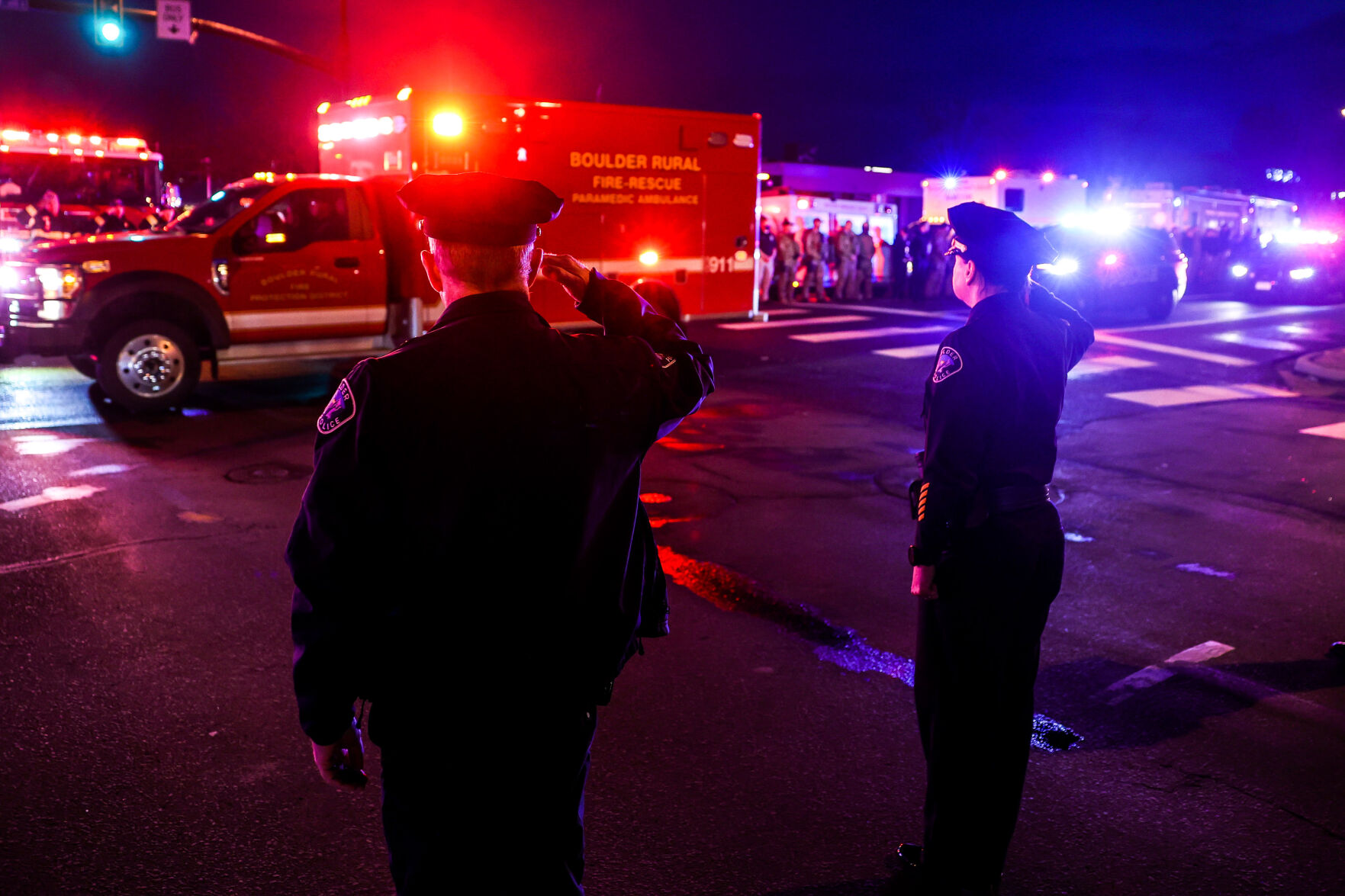 Police officers salute as emergency vehicles escort the body of a slain police officer from the scene of a shooting at a King Soopers on Monday, March 22, 2021 in Boulder. Ten people were killed in the shooting. (Michael Ciaglo/Special to The Denver Gazette) (Michael Ciaglo/Special to The De)