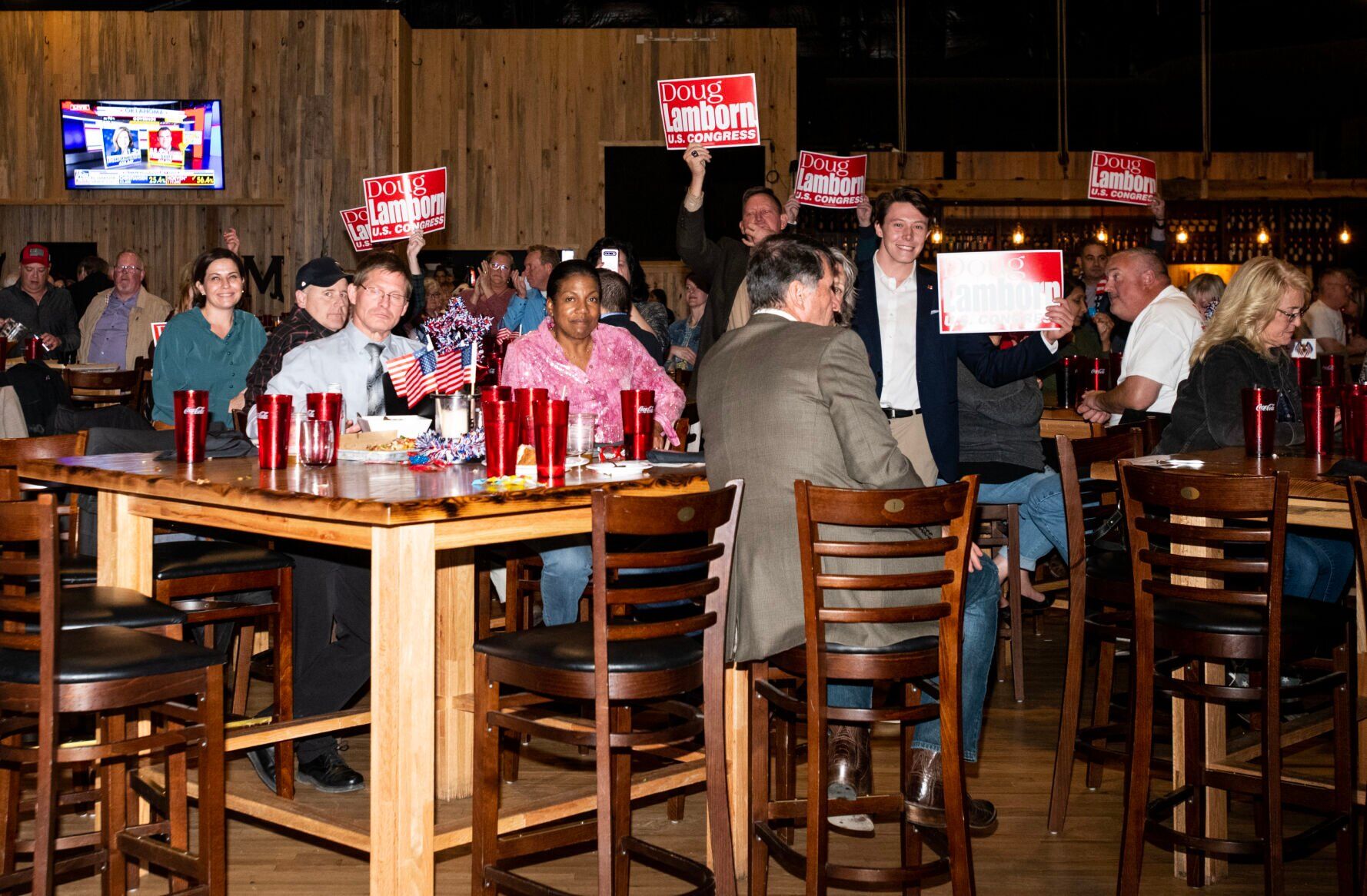 Supporters of Congressman Dough Lamborn hold signs as he give s speech at the El Paso Republican’s election watch party at Boot Barn Hall at Bourbon Brothers on Nov. 8, 2022. (The Gazette, Parker Seibold) (Parker Seibold)