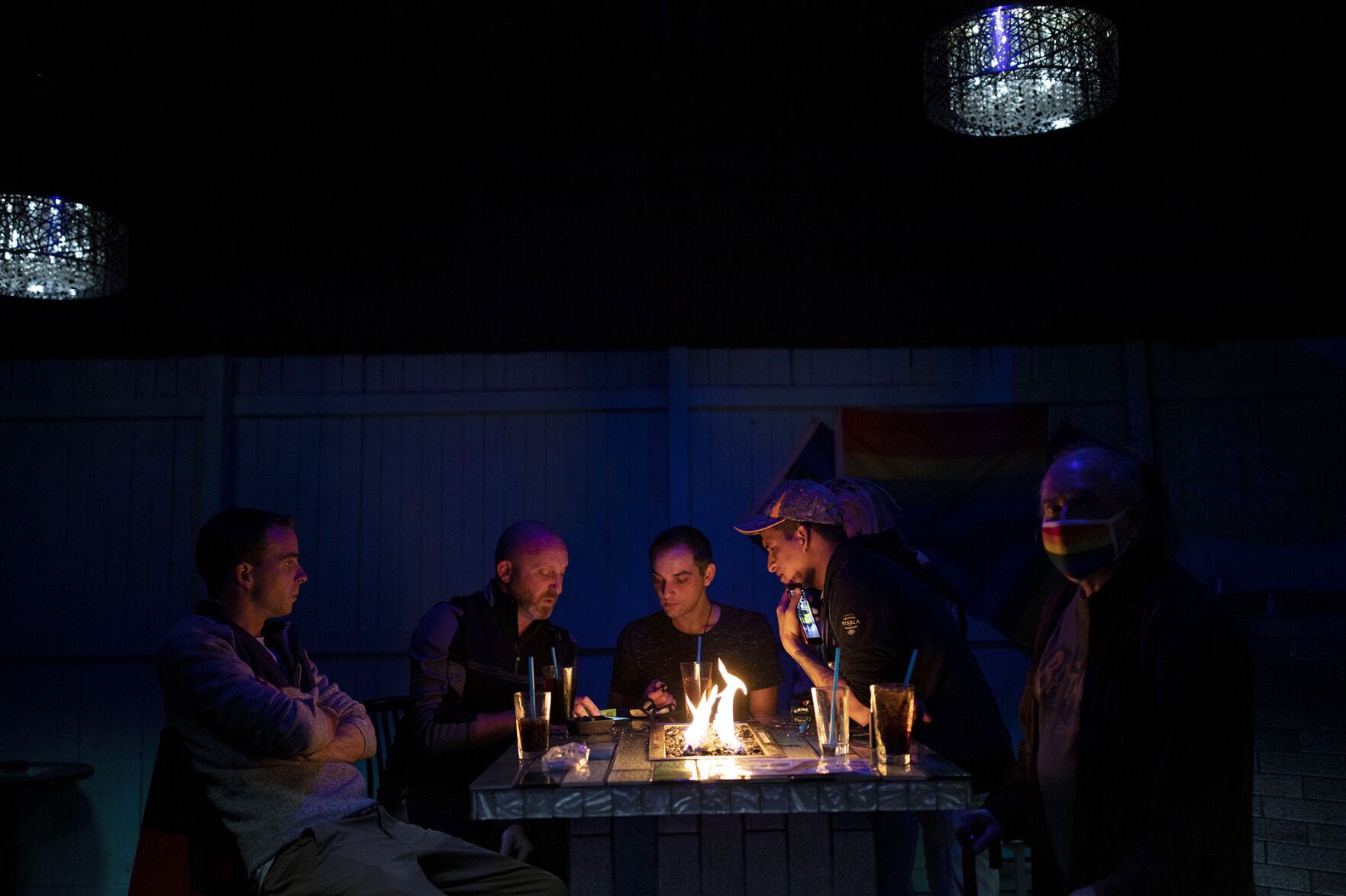 From the left, Evan Hooton, co-owner Nic Grzecka, Derrick Rump, Stefan Bennett, Jacob Gohl and Ed Sanders watch and discuss election results on Grzecka's phone during a watch party at Club Q in Colorado Springs, Colo., on Tuesday, Nov. 3, 2020. (Chancey Bush/ The Gazette) (Chancey Bush The Gazette)