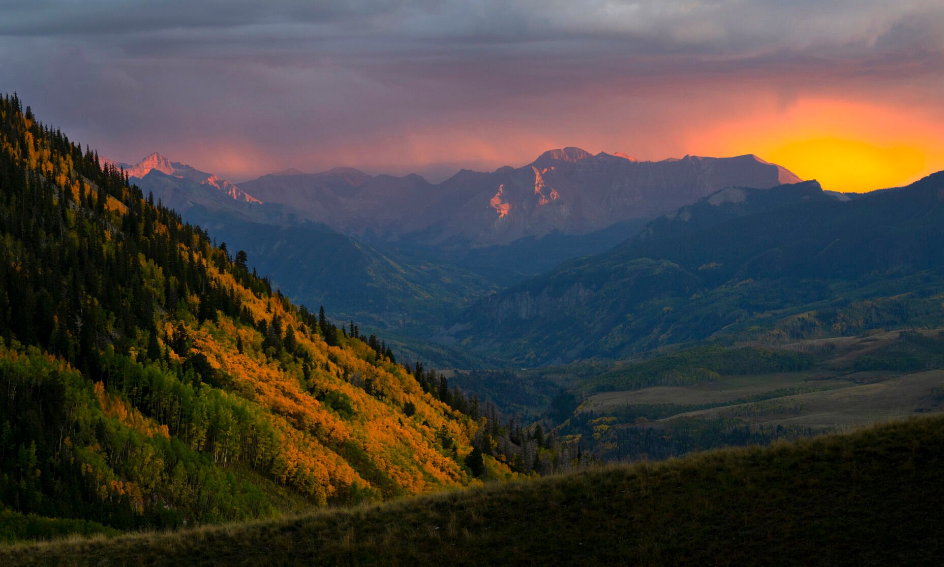 The setting sun paints the sky red as a storm hits the San Juan Mountains near Telluride. (Christian Murdock, The Gazette)