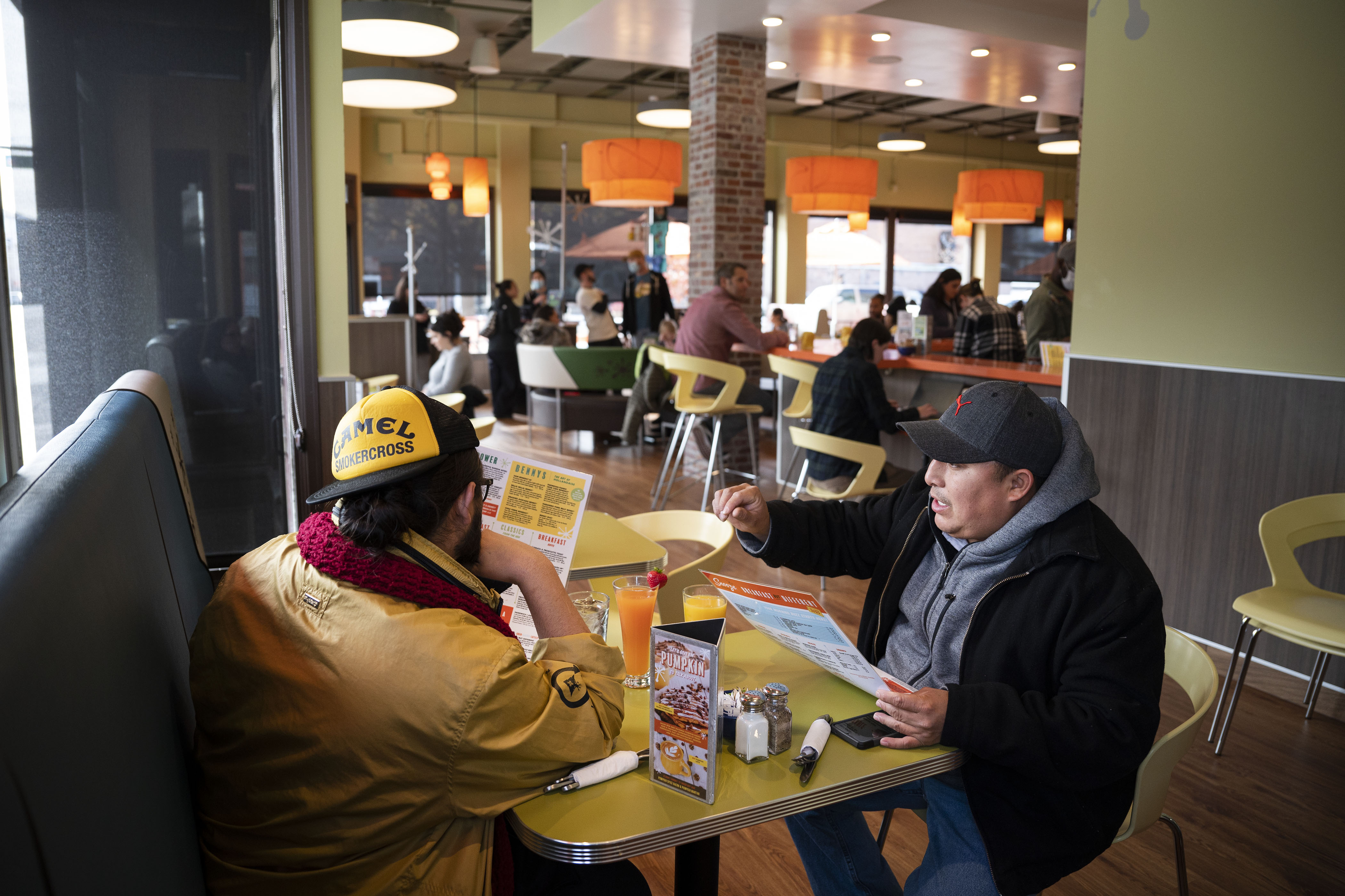 Friends Juan Serna and Jose Chab look over the menu before ordering breakfast at Snooze an A.M. Eatery on Wednesday, Nov. 16, 2022, on North Broadway in Denver. (Timothy Hurst/The Gazette) (TimHursttim.hurst@gazette.comhttps://secure.gravatar.com/avatar/aca82bd62b4ee425c598527cd6faa1b1?d=mm&r=g)